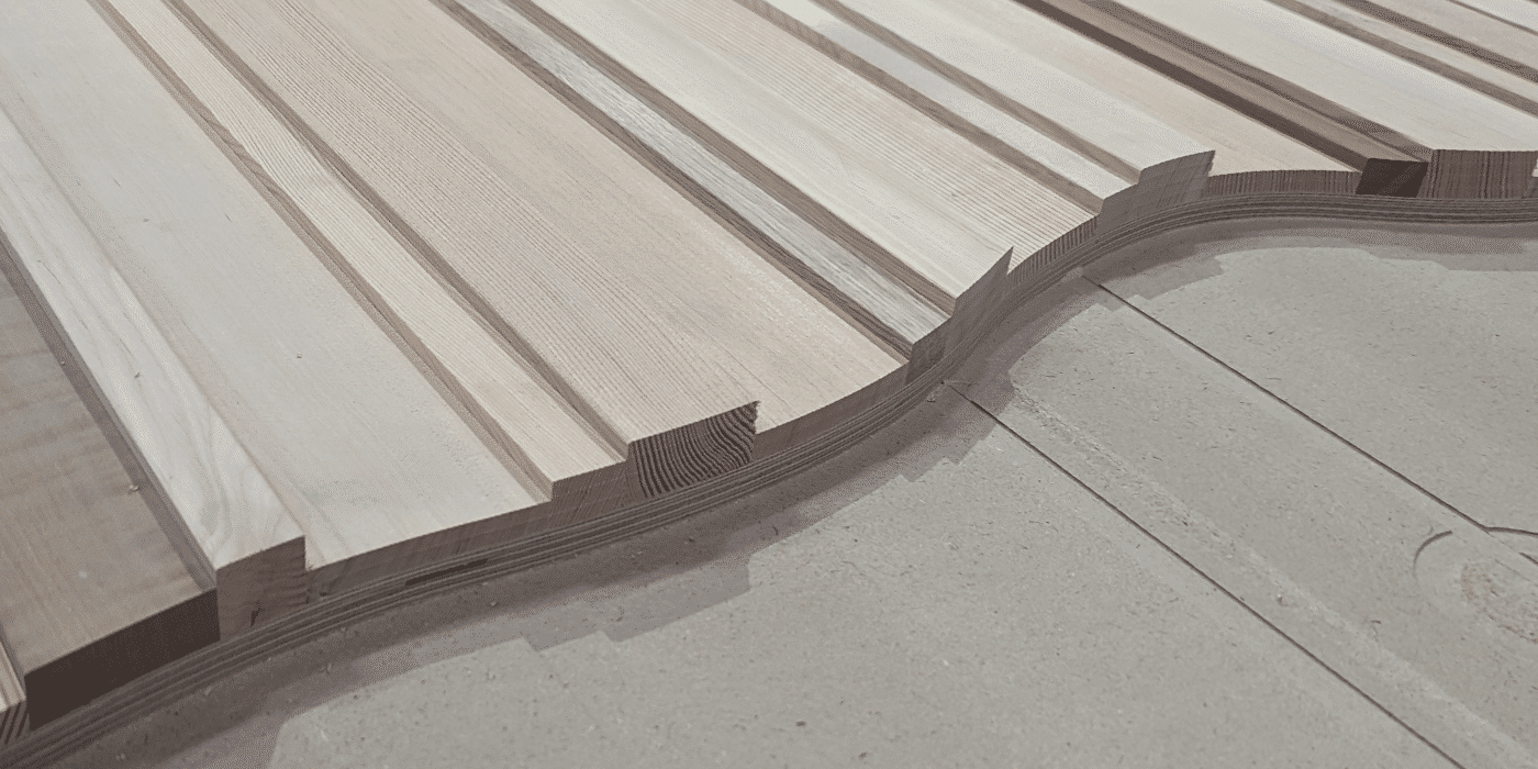 A long granite counter with several red chairs along one side in a cafeteria or dining area
