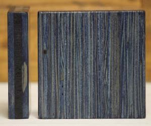 Close-up of a computer keyboard and a computer mouse on a wooden desk.