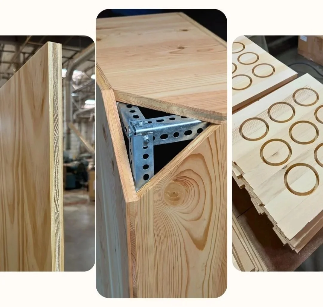 Six wooden planks with different colors and finishes standing upright on a wooden surface.