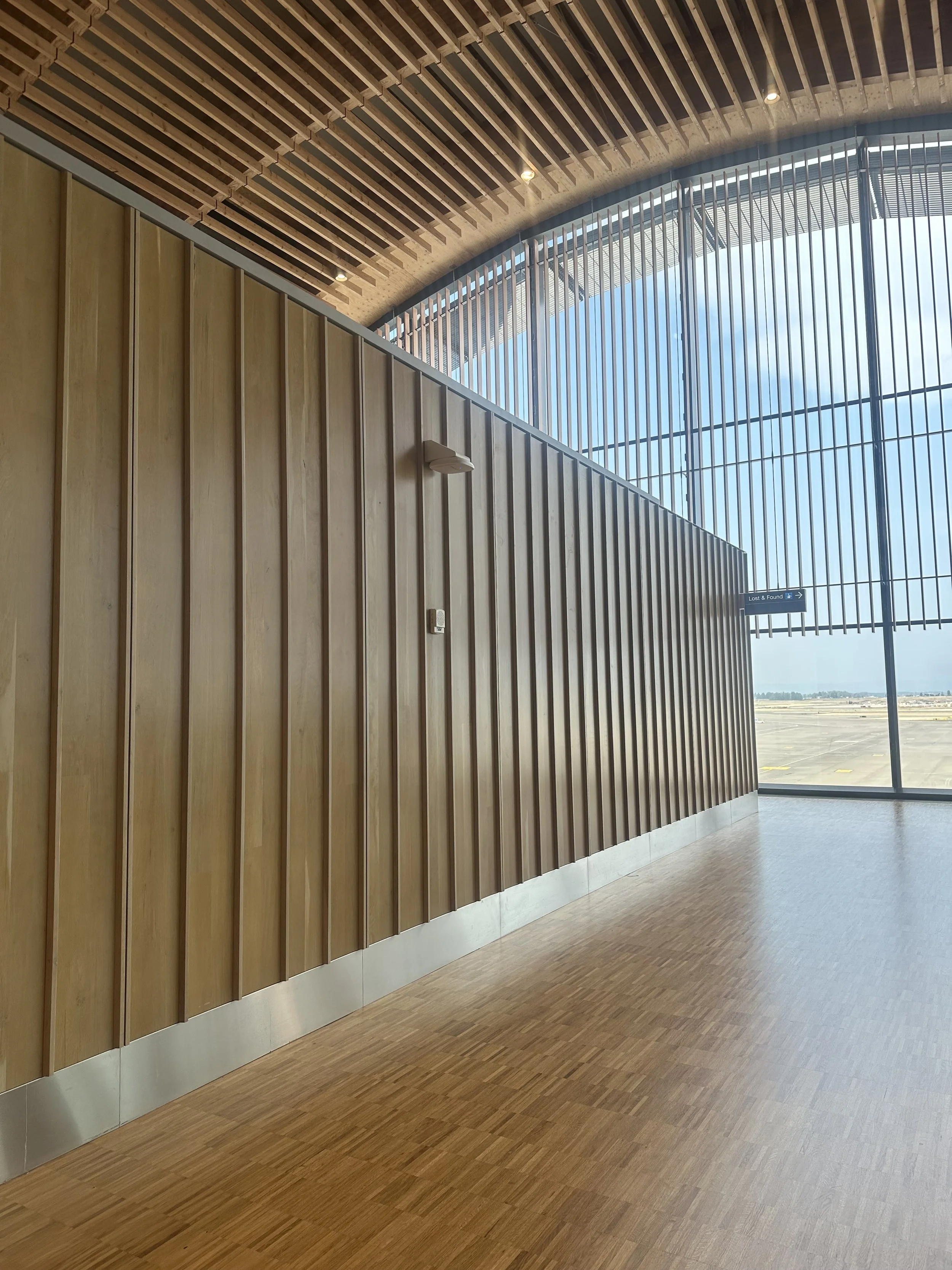 A tall, rectangular wooden box with a partially open top revealing metal framing inside.