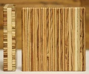 Two wooden blocks with striped patterns, one taller and thinner, the other shorter and wider, on a wooden surface.
