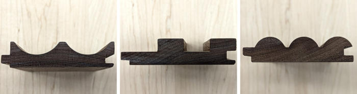 Three wooden boat-shaped decorating shelves with various wave-like designs, displayed on a light wood surface.