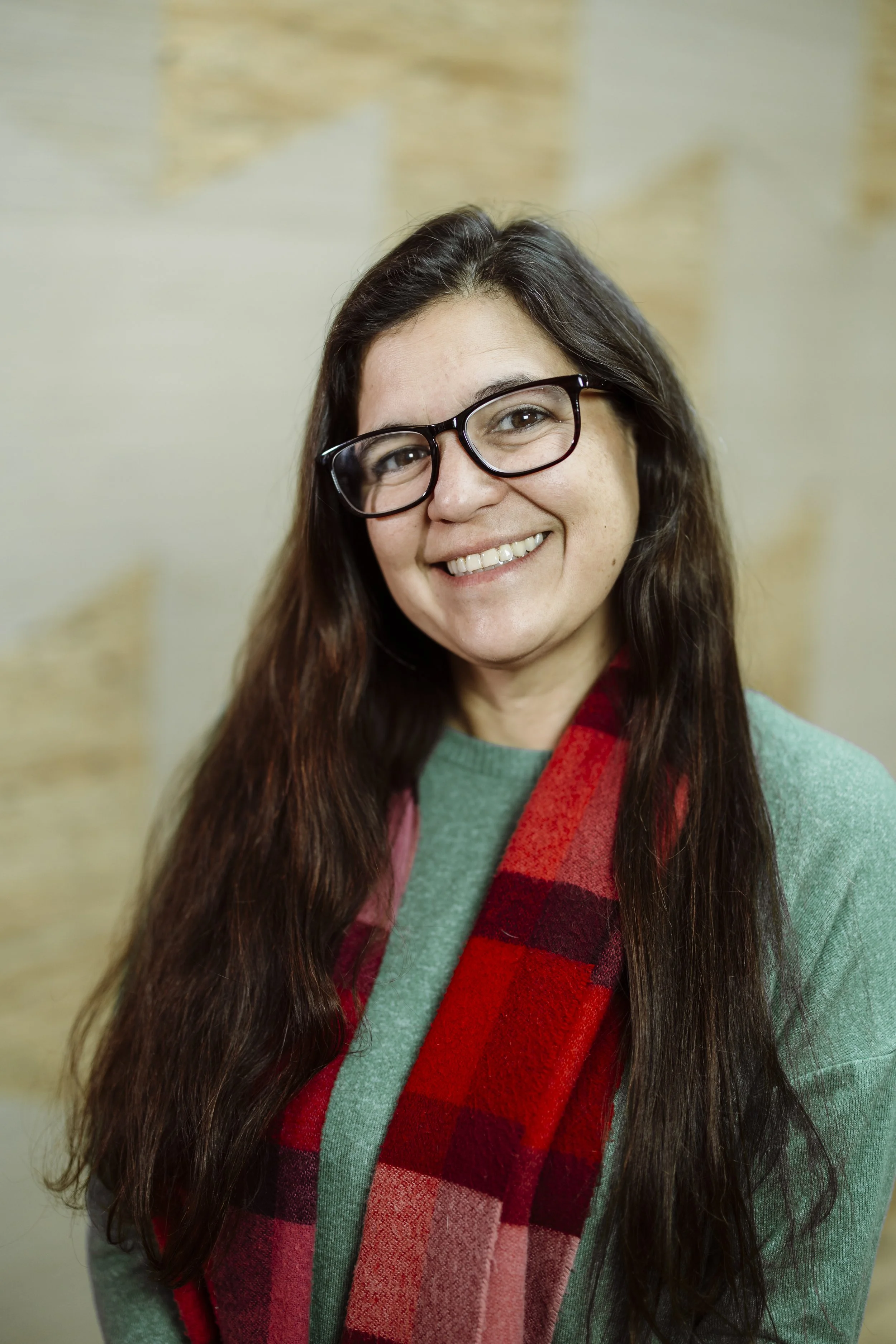 Smiling woman with dark hair and glasses