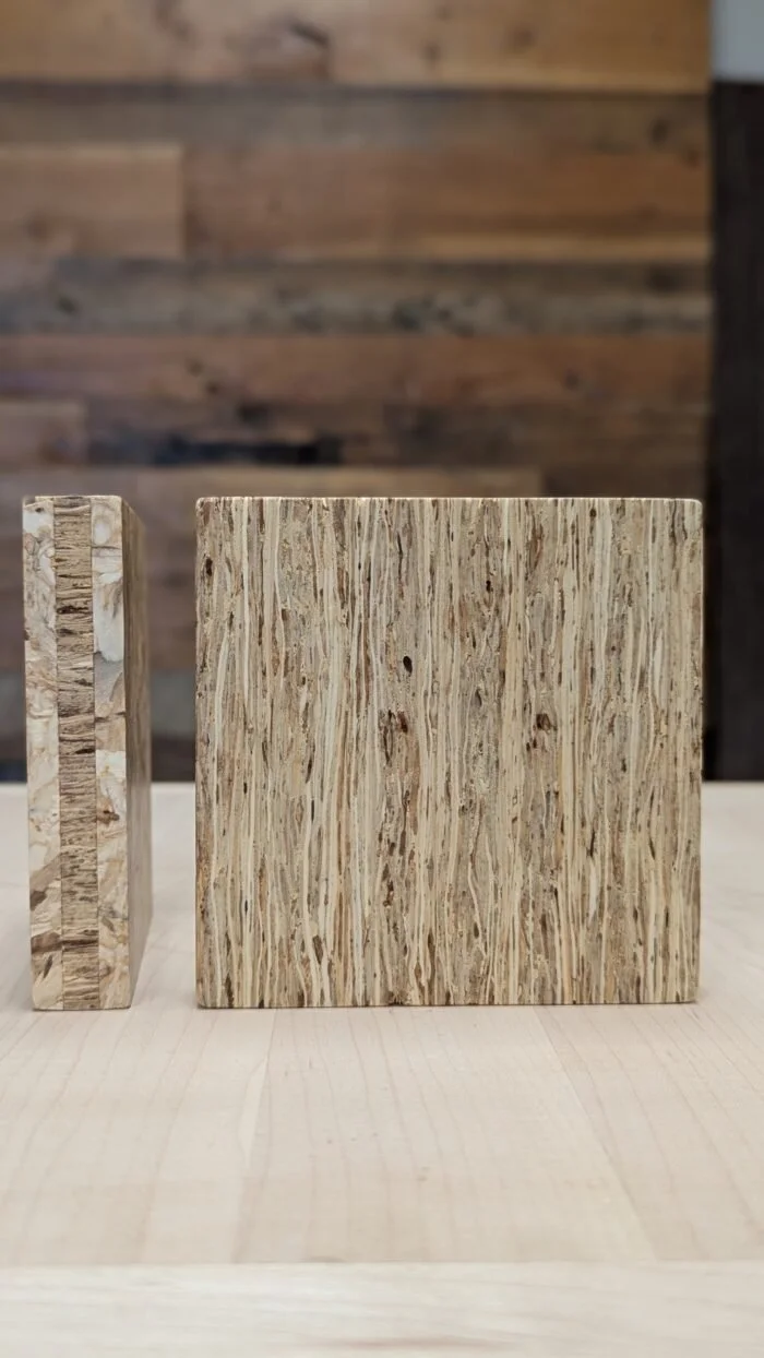 Close-up of two wooden blocks, one larger and one smaller, on a light wooden surface with a background of darker wood planks.