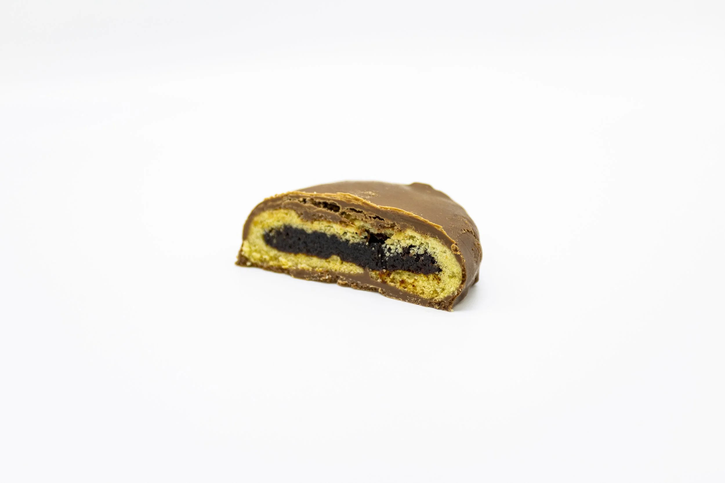 Cross-section of a chocolate-filled cookie with a yellow cookie exterior on a white background.