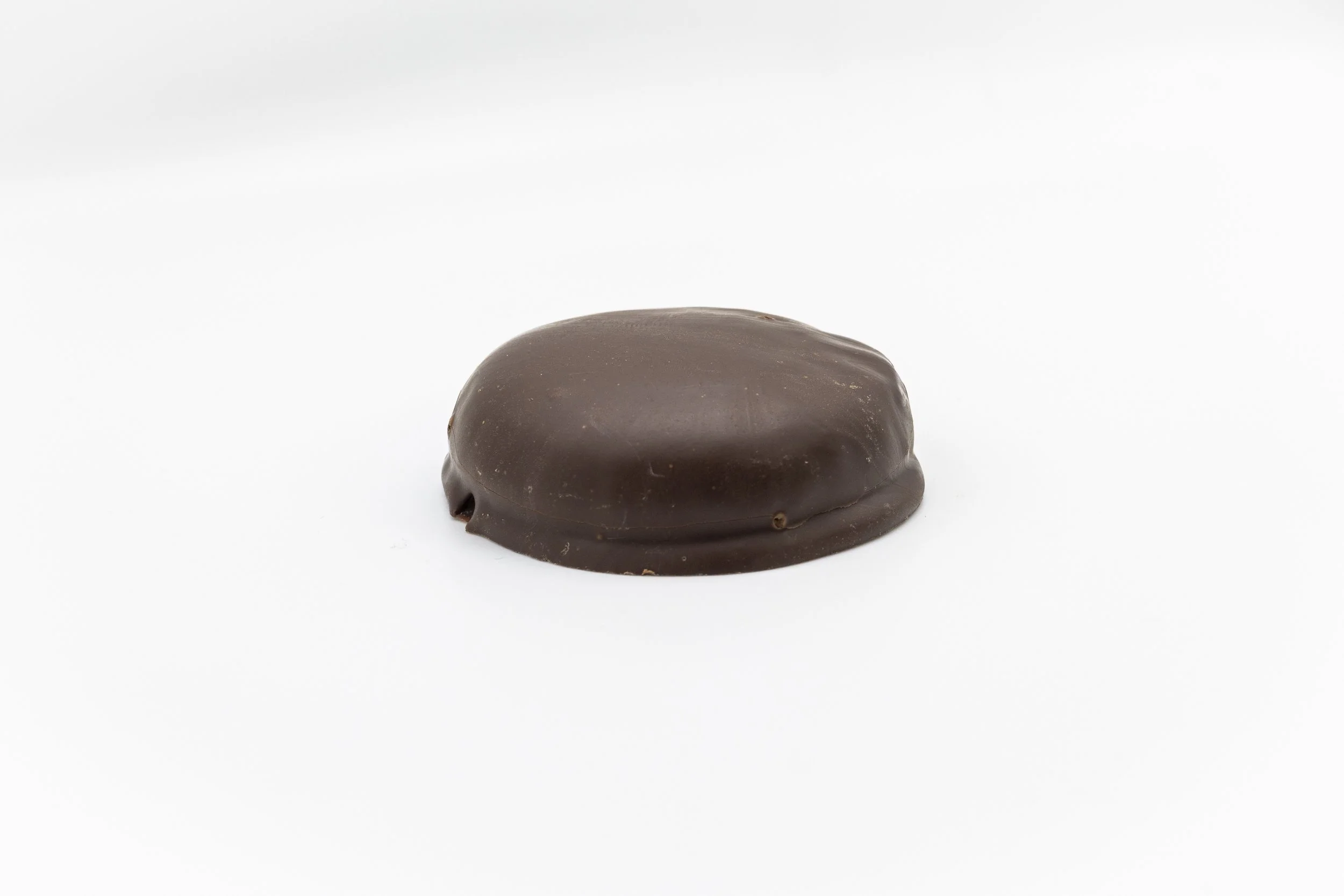 A single chocolate-covered confectionery item on a white background.