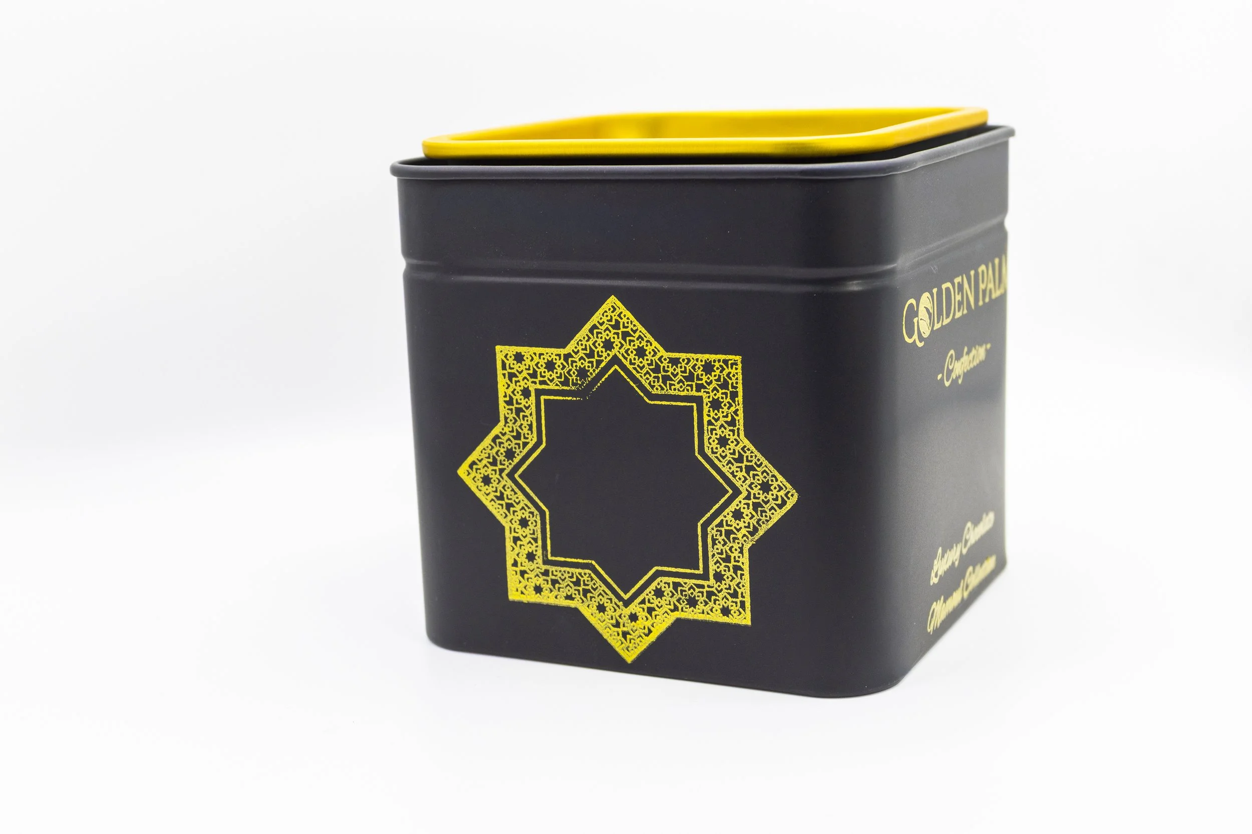 A black metal container with a yellow geometric star design on the front and the words "GOLDEN PALACE" in gold letters on the side, set against a plain white background.