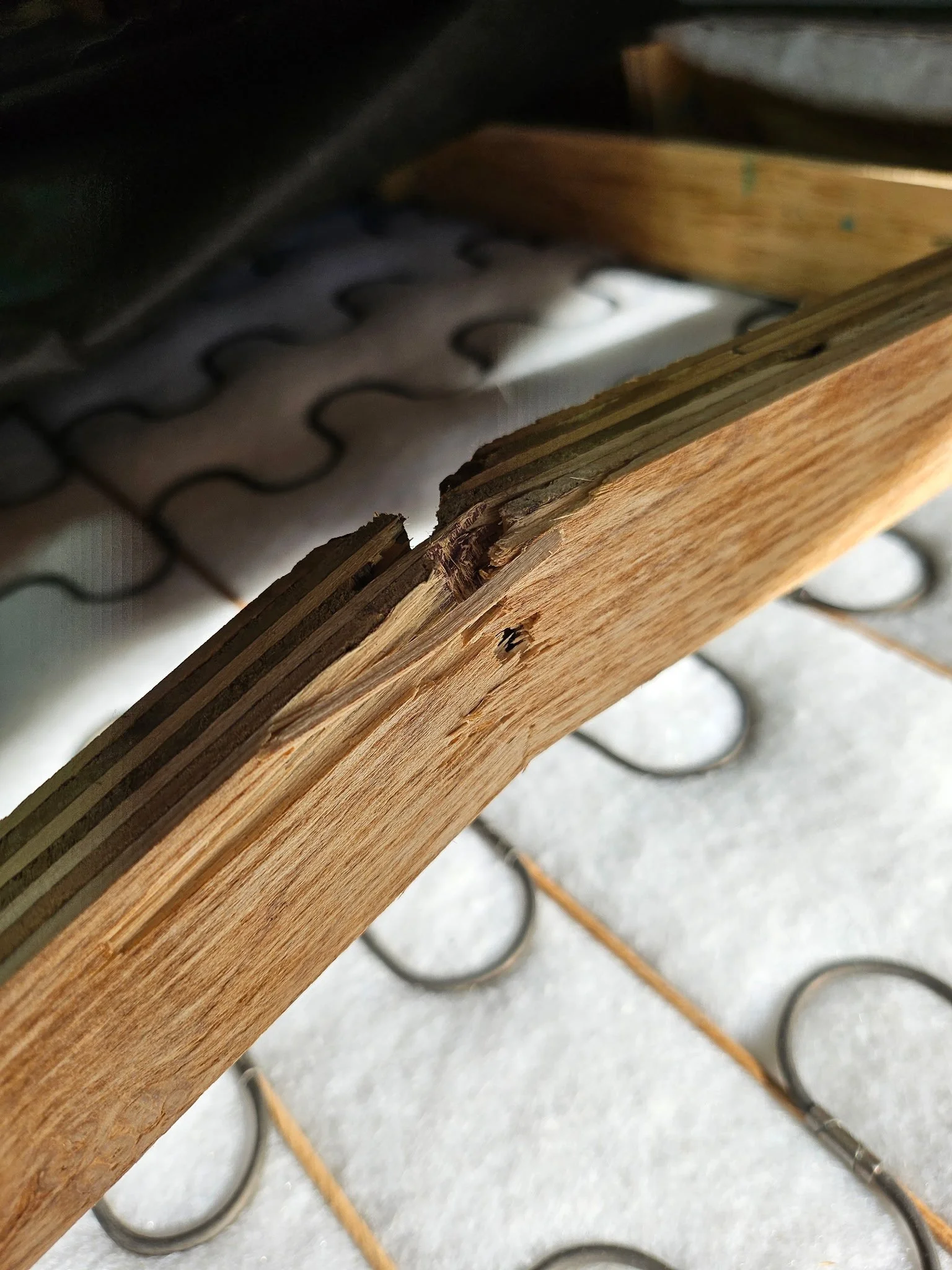 Close-up of broken wood furniture rail before structural repair