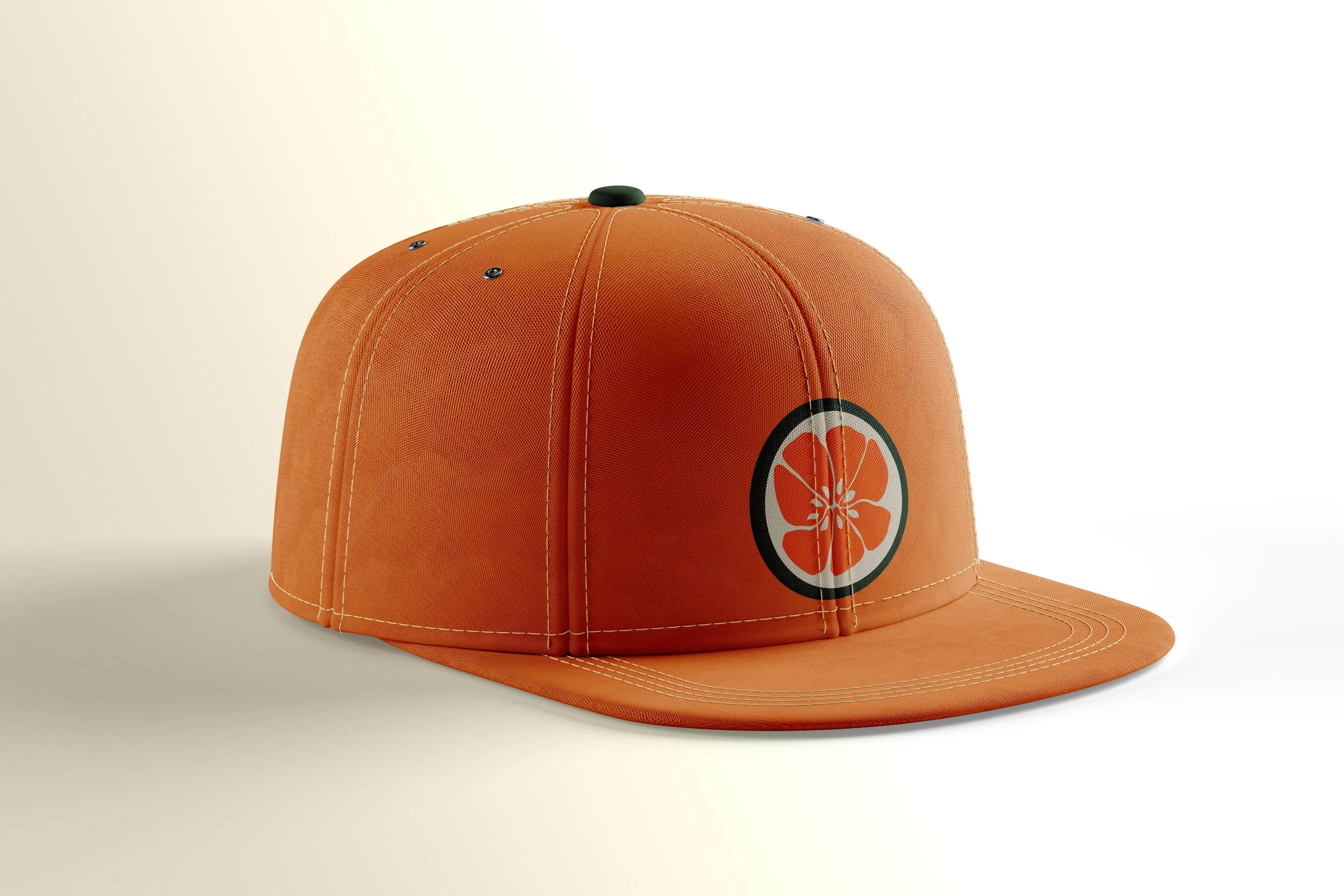An orange baseball cap with a citrus fruit design on the front, featuring a slice of orange with seeds, outlined in black.