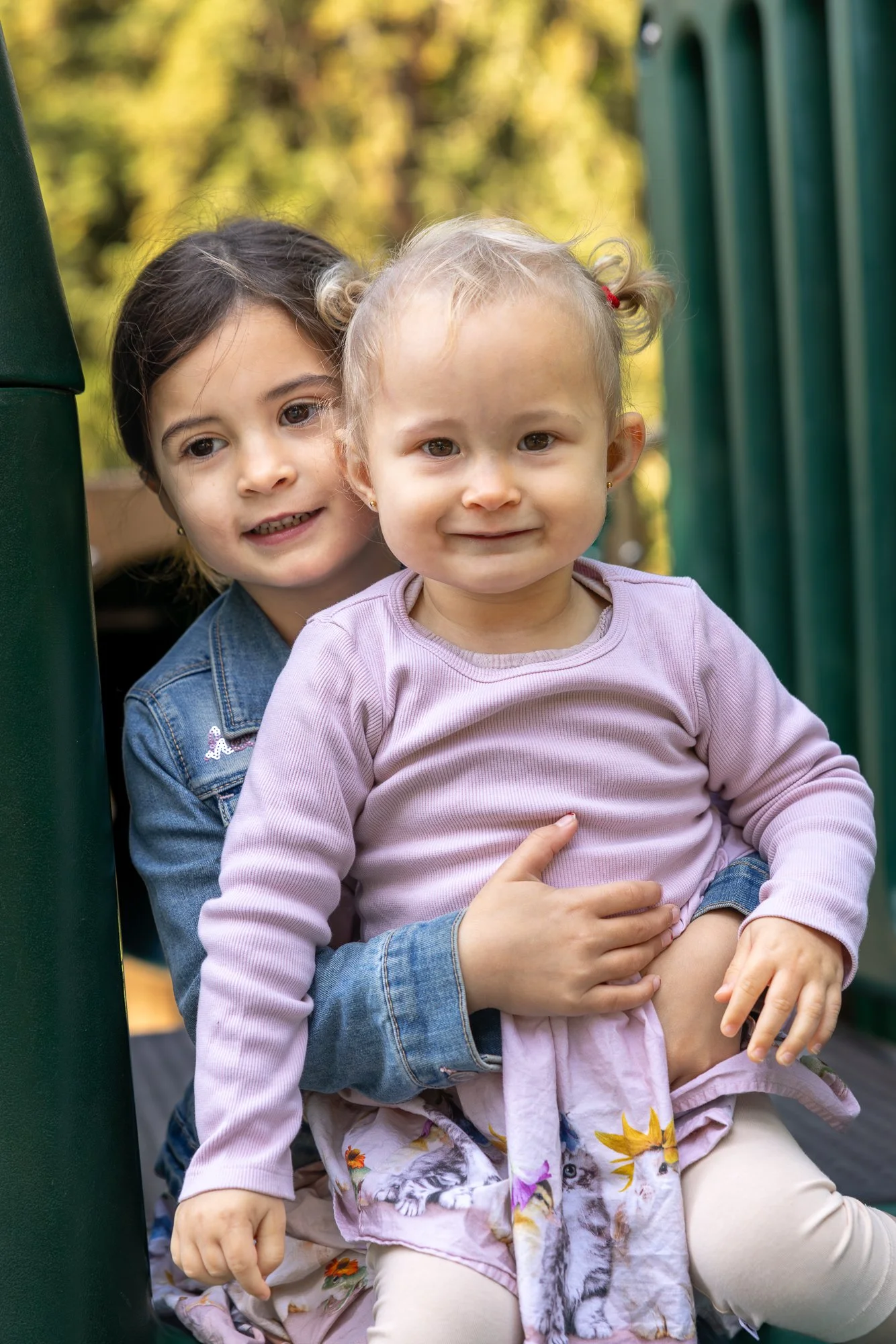 Two sisters playing on playground at Shoup Park Los Altos family session