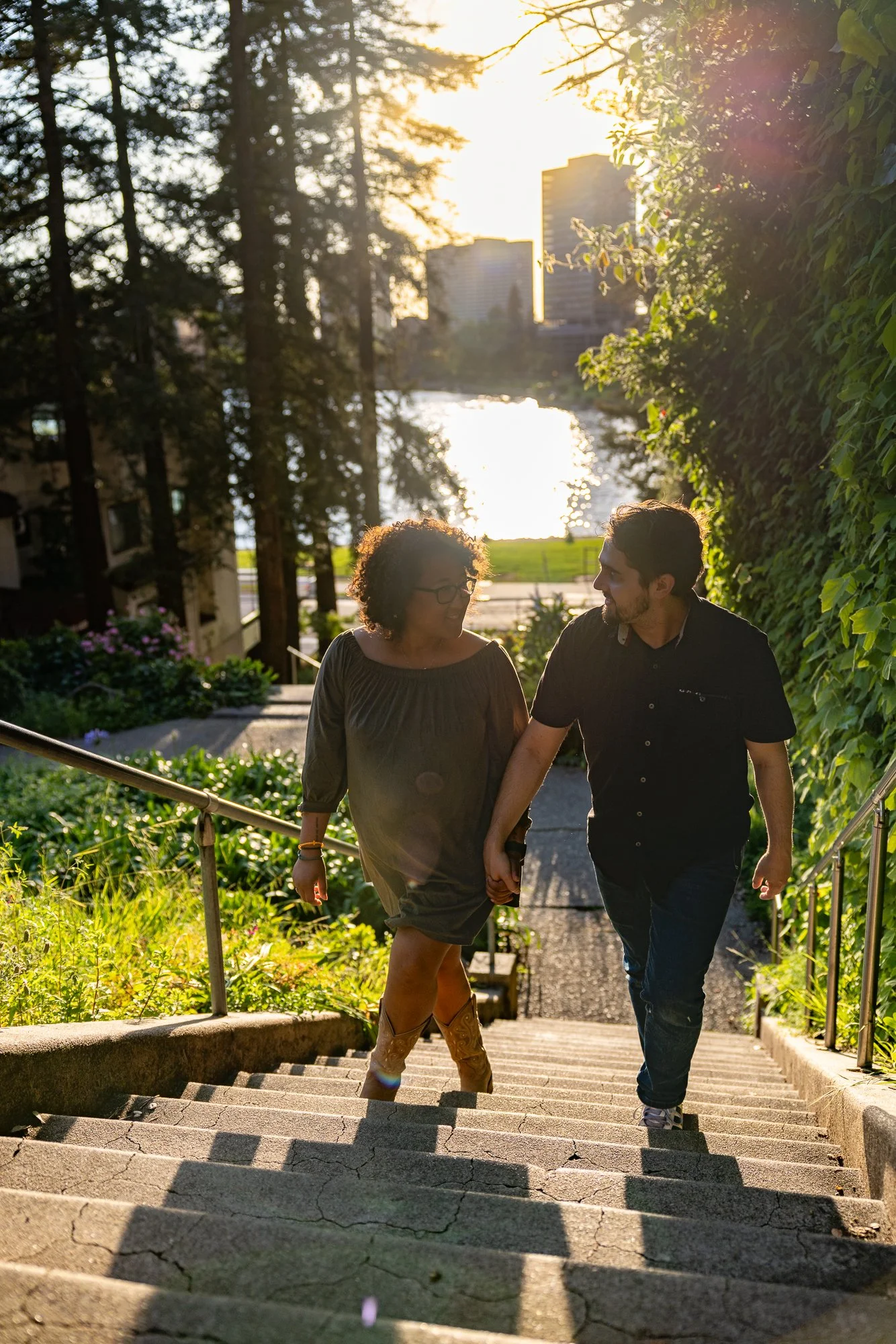 Bay Area couples photographer golden hour walk up cascade stairs with sun flare