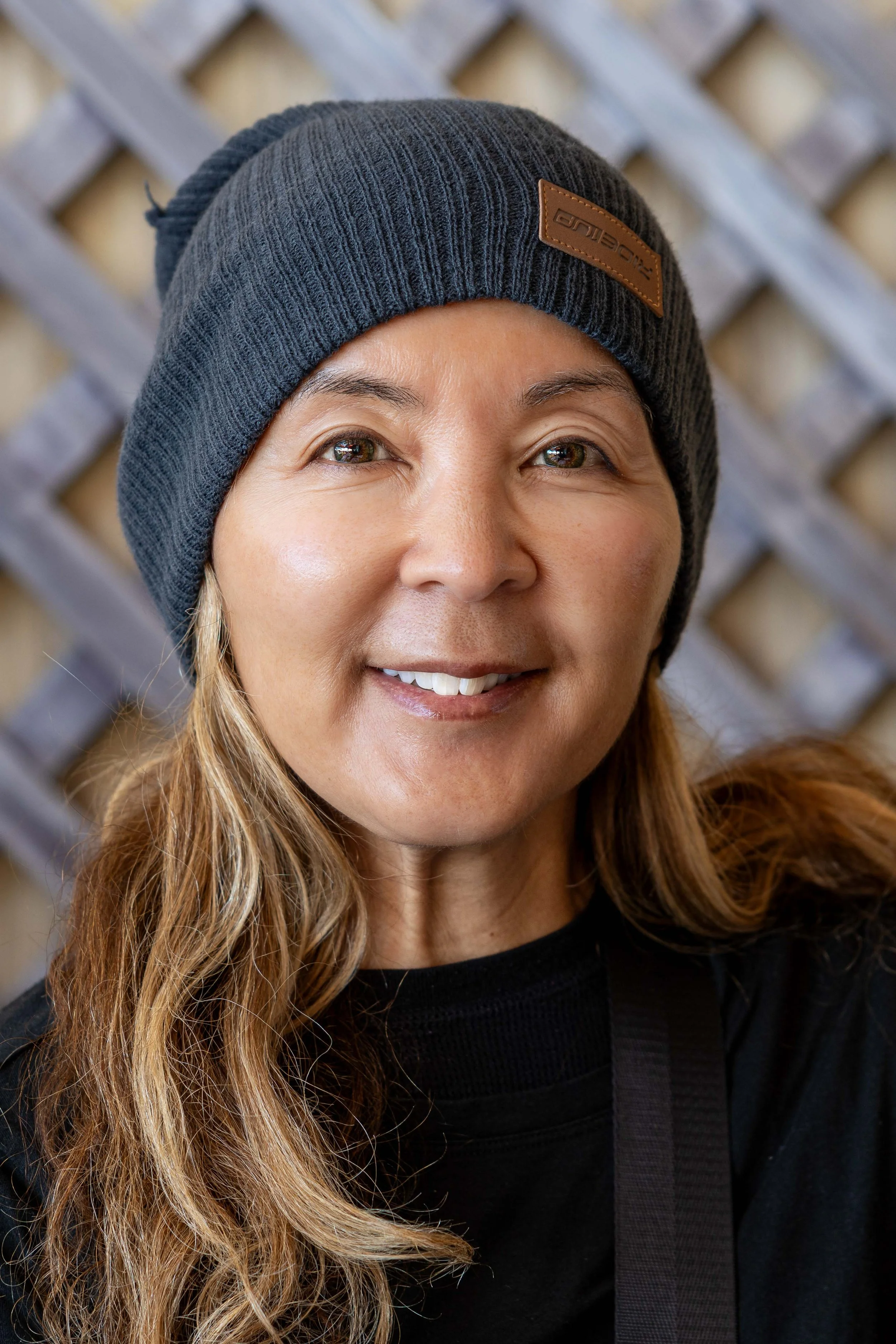 Natural smile mid-ride during a wildflower stop on 17 Mile Drive — Bay Area outdoor portrait and adventure photography session, Pacific Grove.