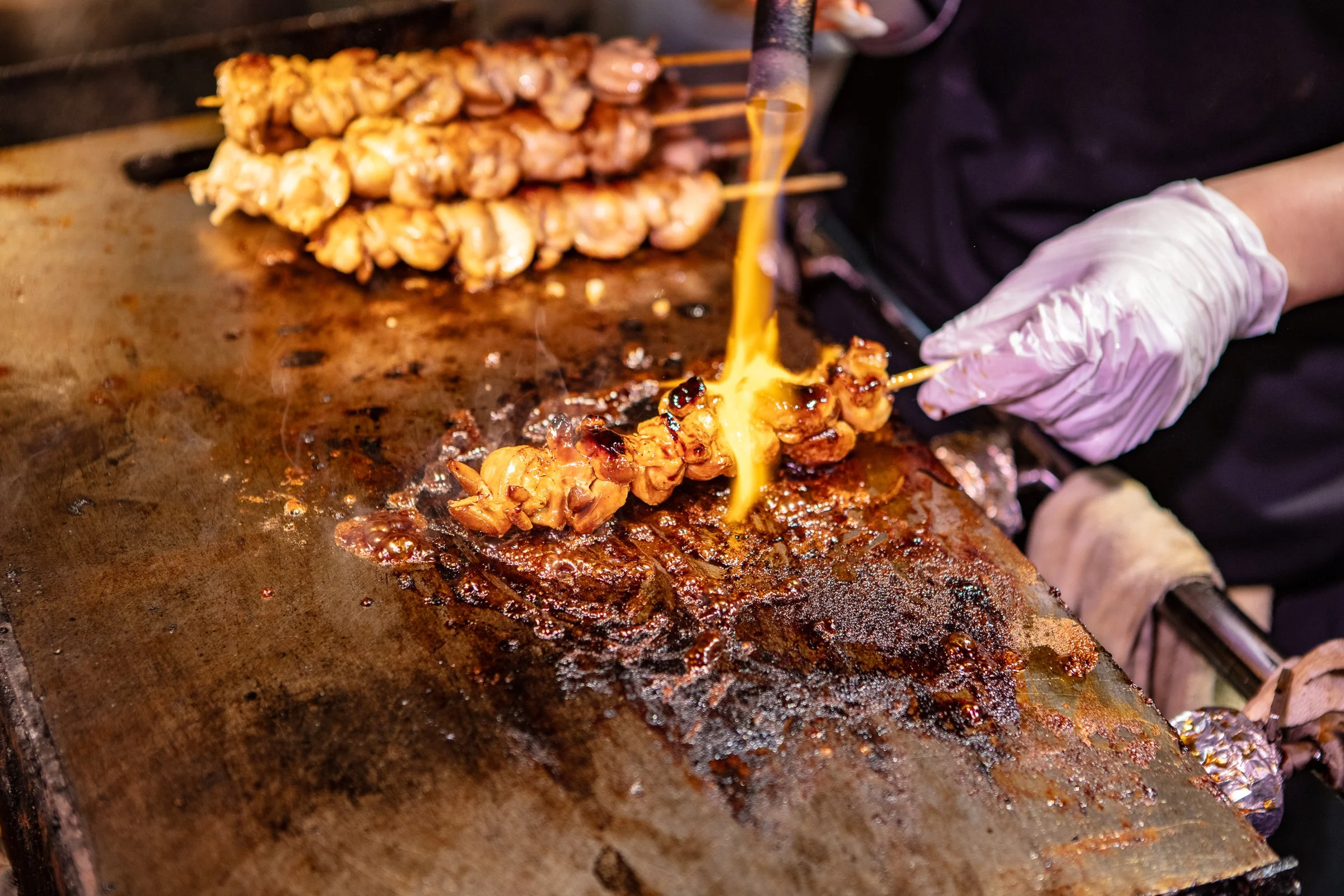 Yakitori chicken skewers open flame grill Shinjuku Tokyo Japan