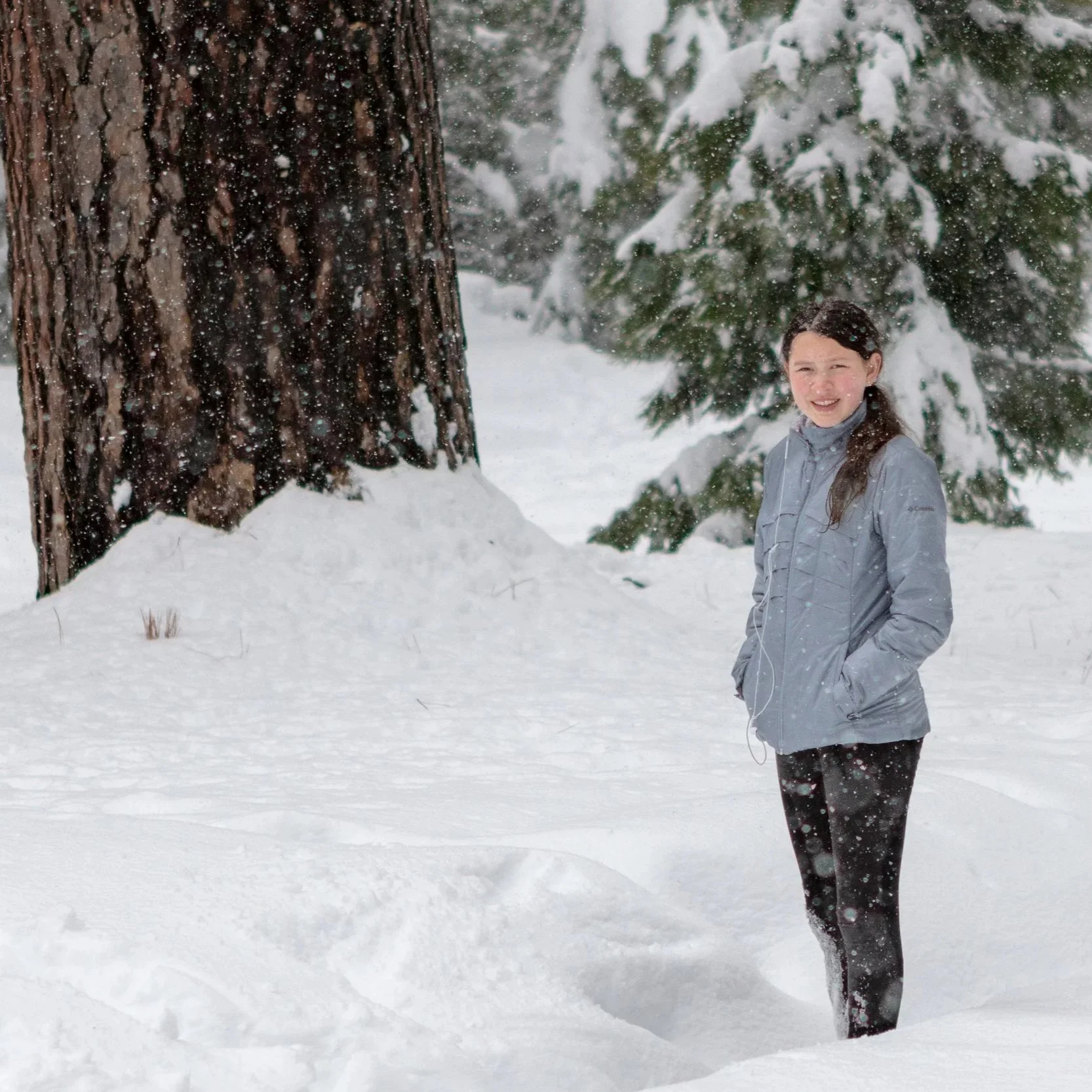 Yosemite National Park Adventure shoot in snow woman standing with headphones on