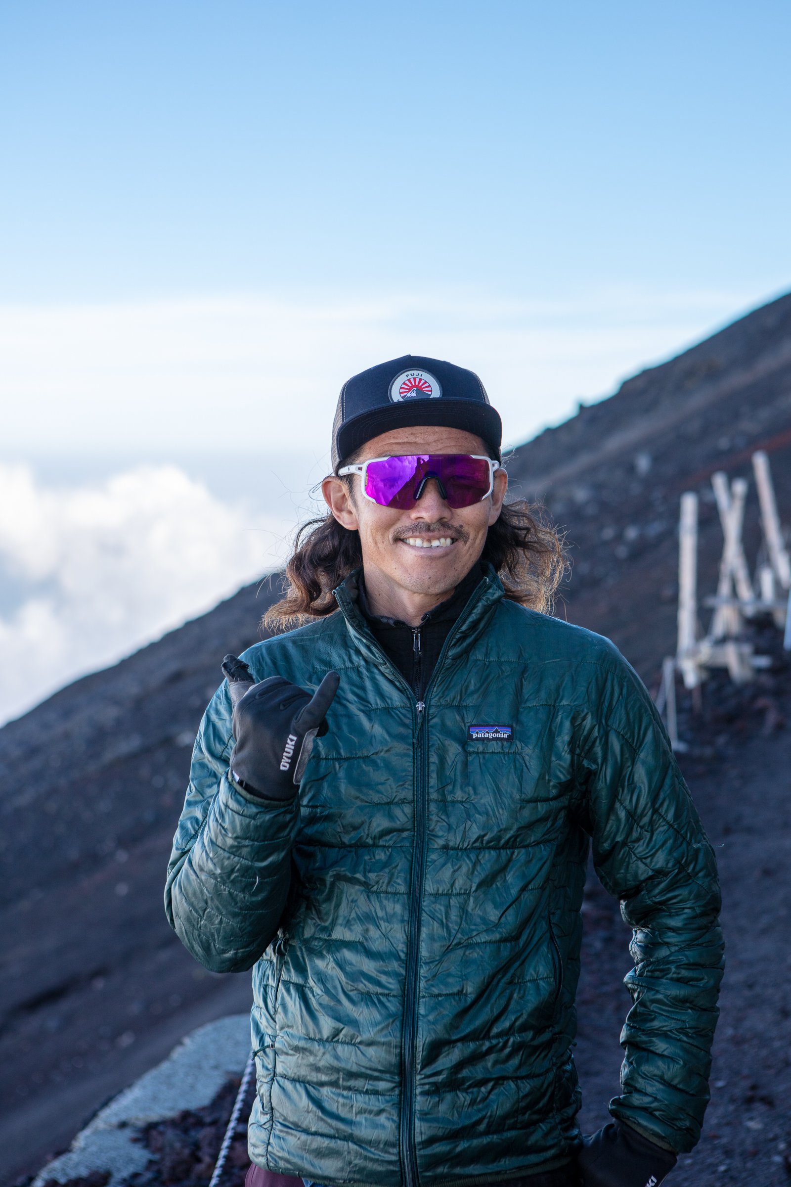 Mt Fuji mountain guide portrait above the clouds Patagonia jacket summit Japan