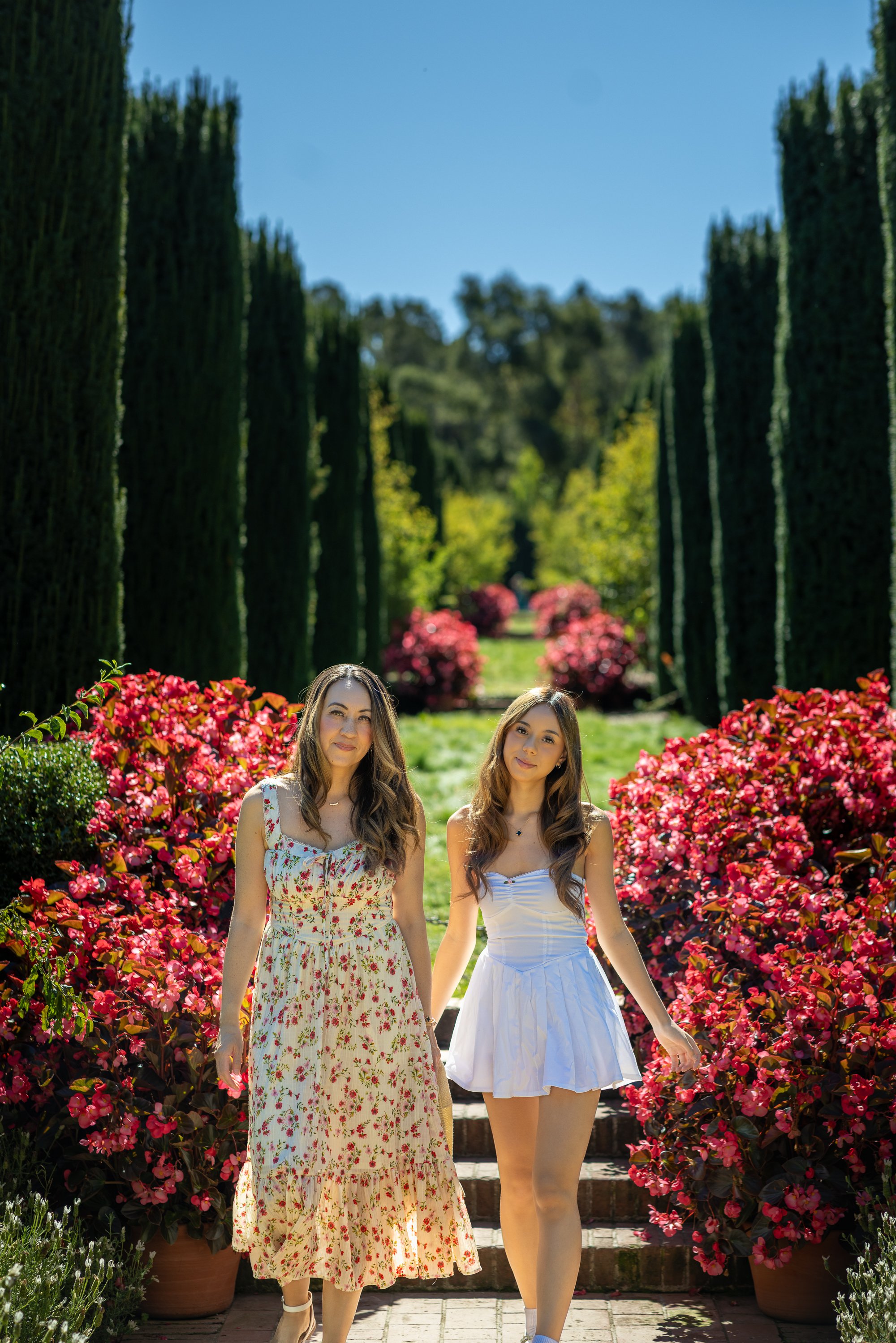 Mother and daughter walking the cypress allée at Filoli graduation session