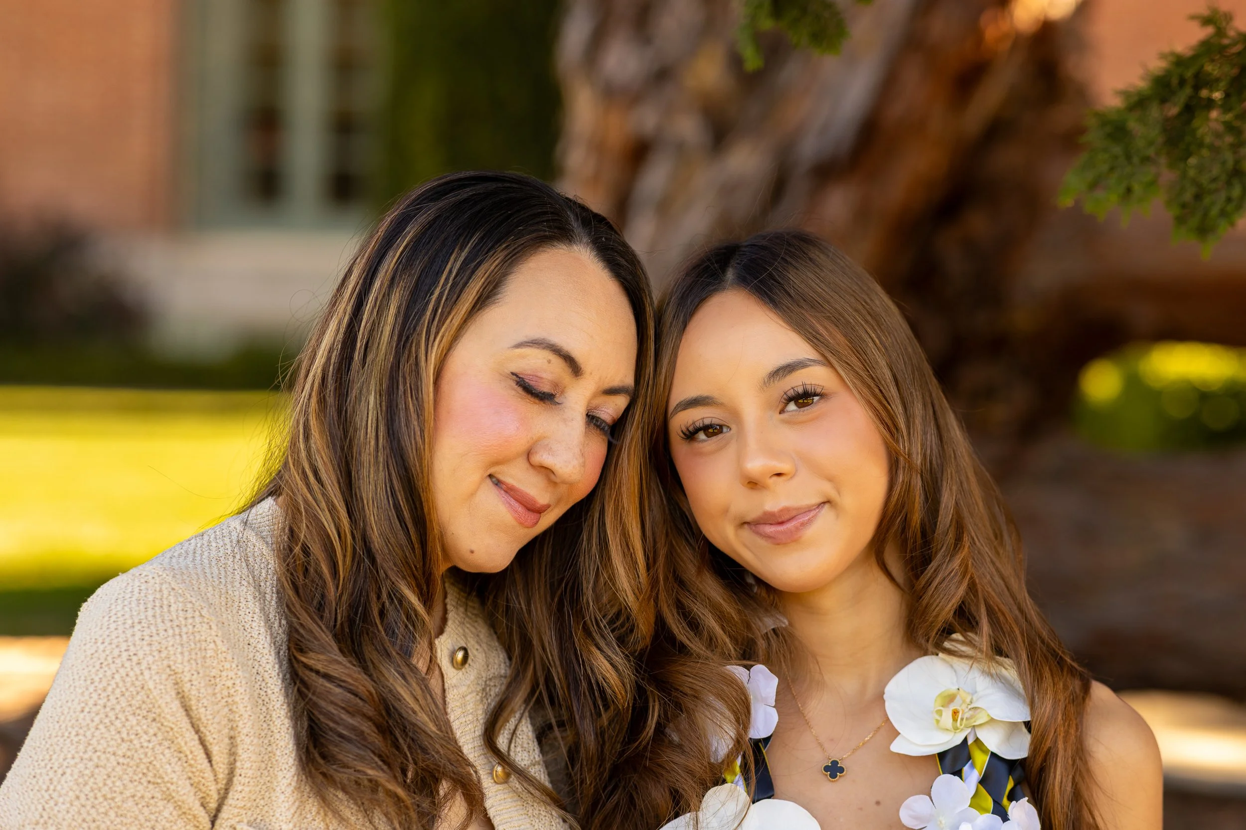 Mother and graduate daughter with foreheads touching at Filoli, Woodside family photos