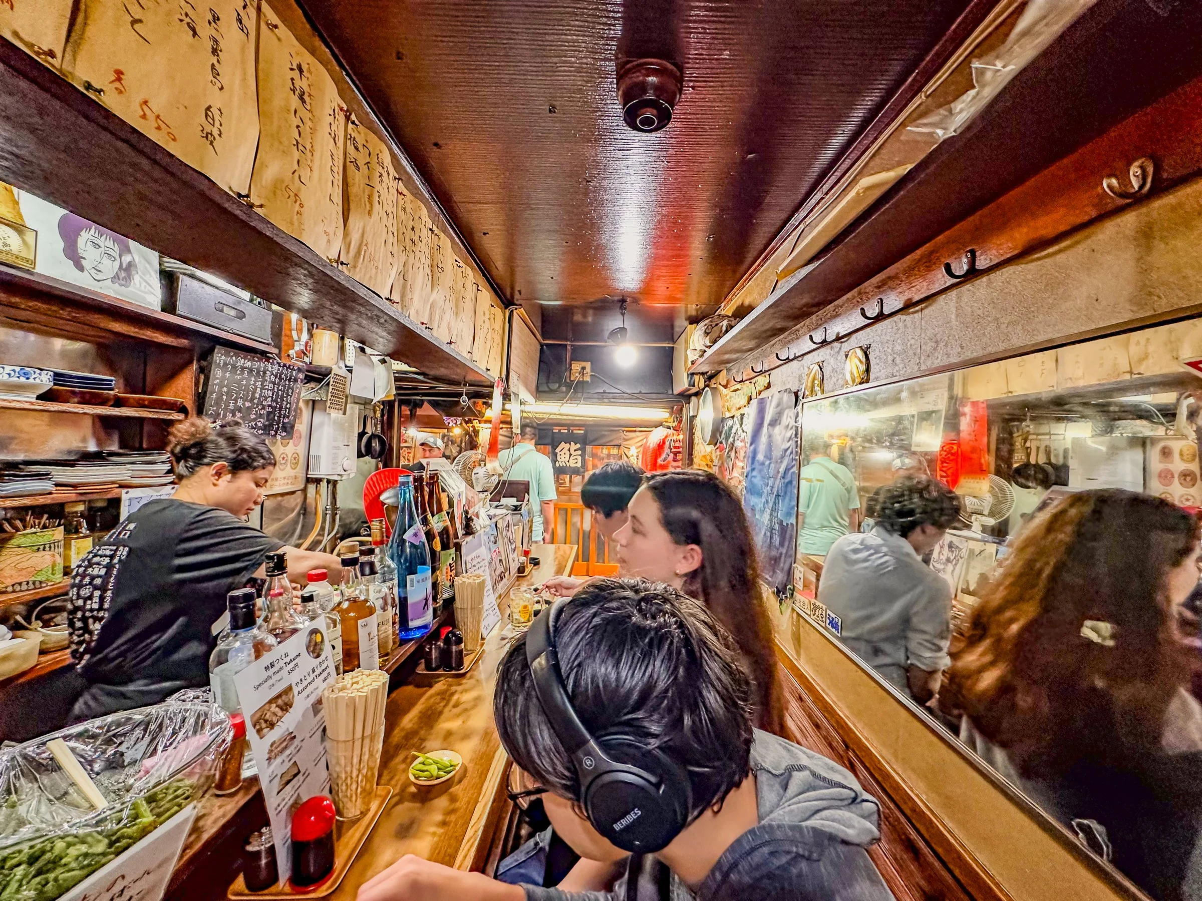 Family dinner izakaya counter restaurant Shinjuku Tokyo Japan