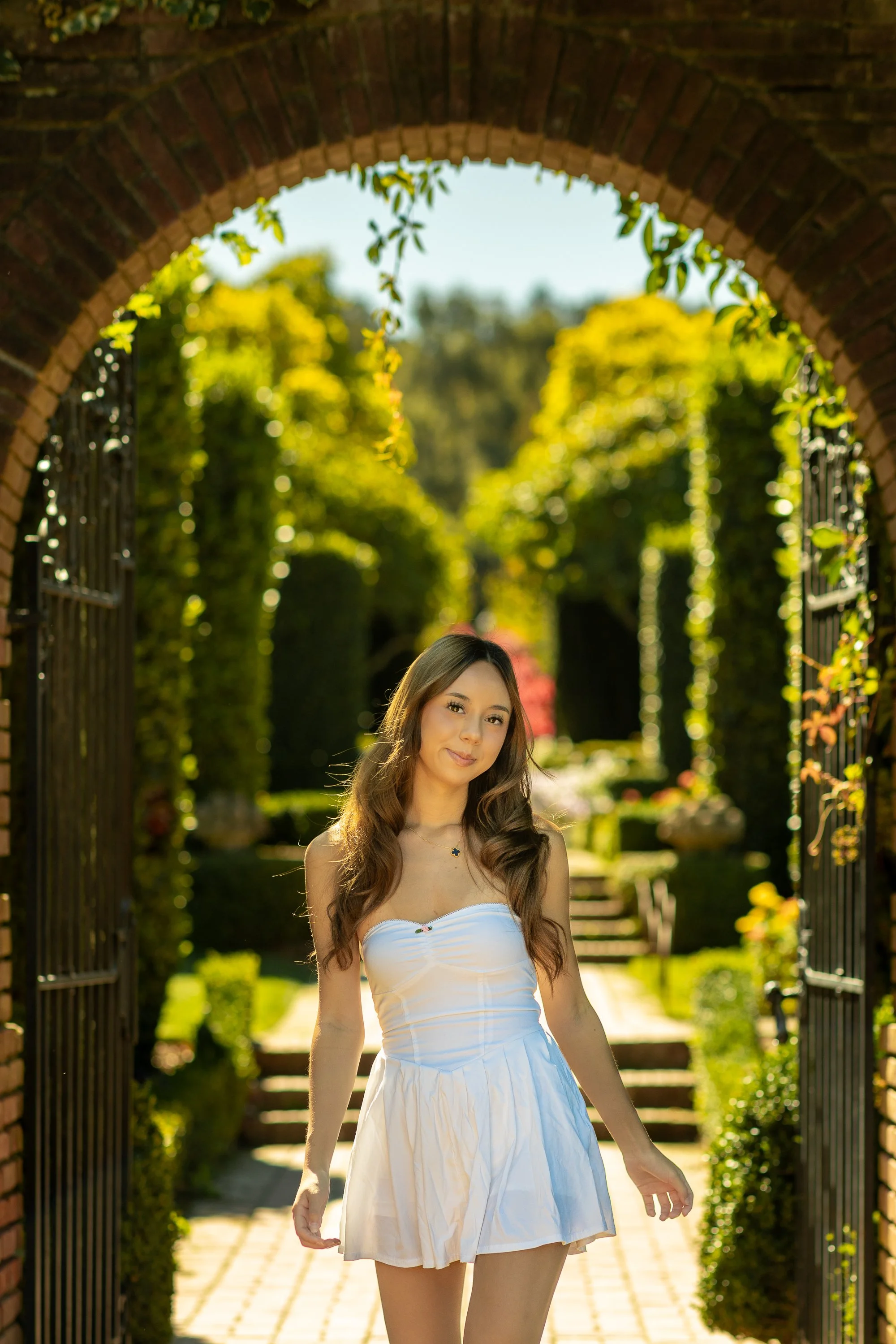 Backlit senior portrait under brick arch at Filoli, Woodside California