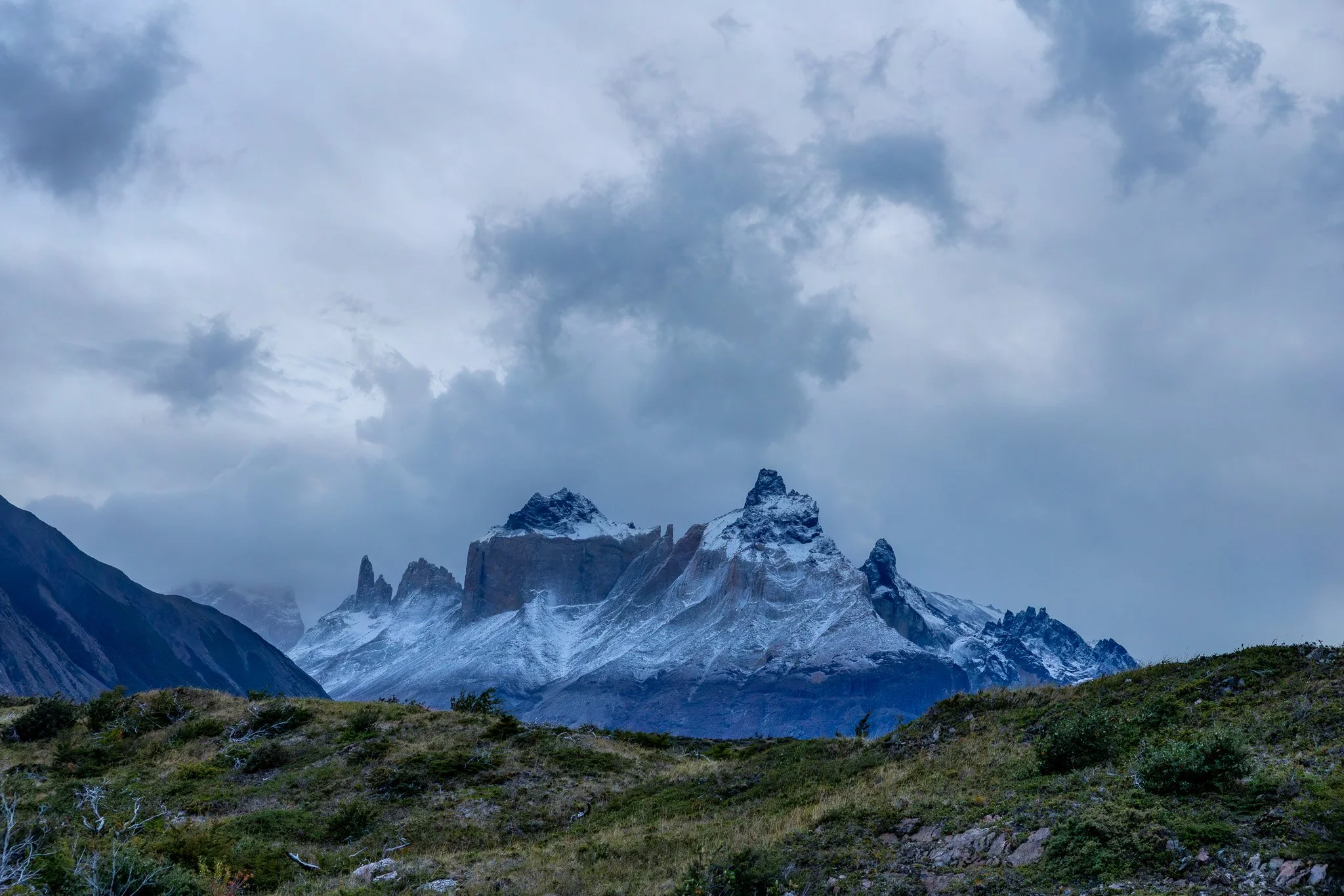 Snow-dusted Los Cuernos massif in moody blue dusk light, Torres del Paine National Park, Chilean Patagonia