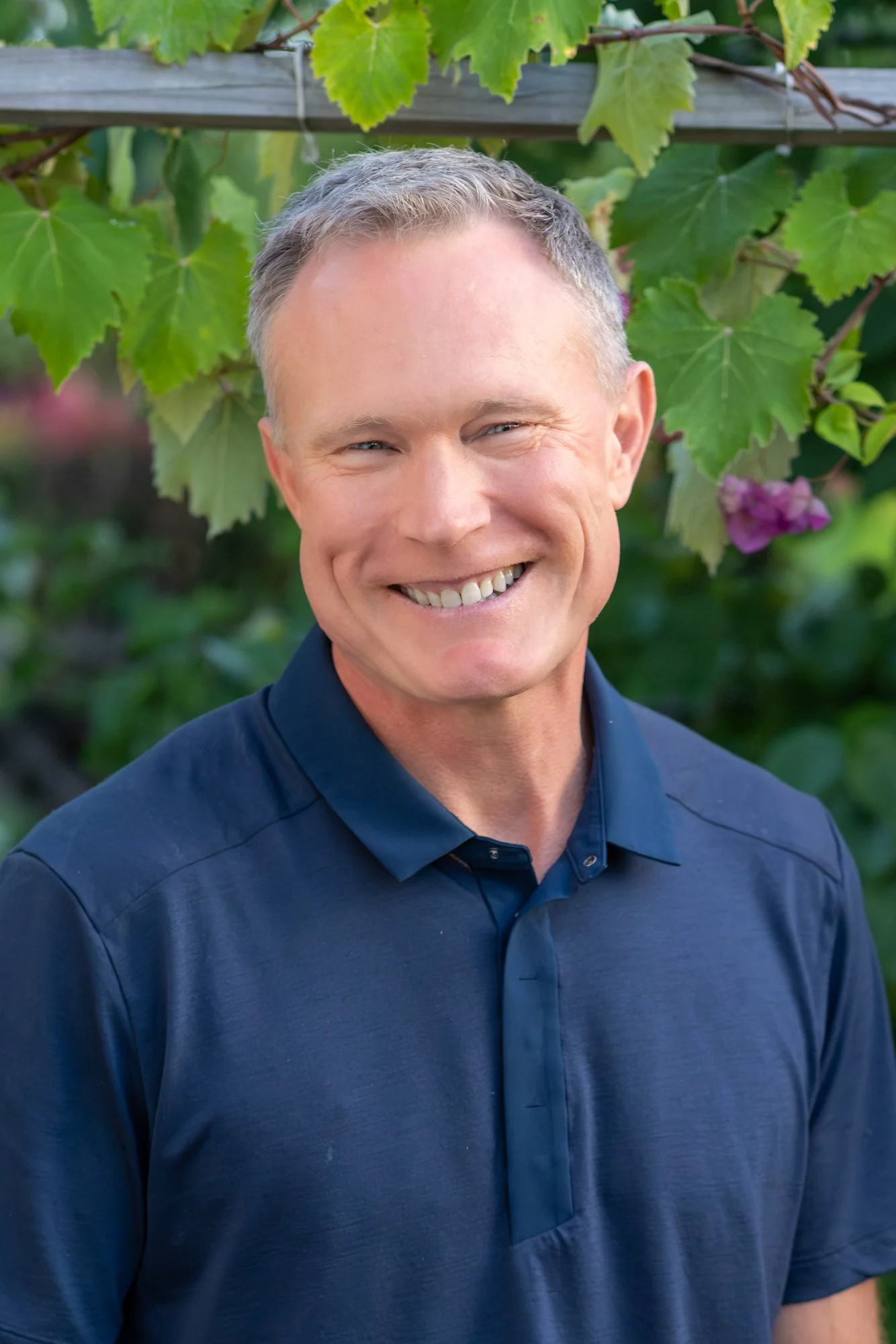 Picture of photographer Matthew Duncan with grape vine in backgrounds