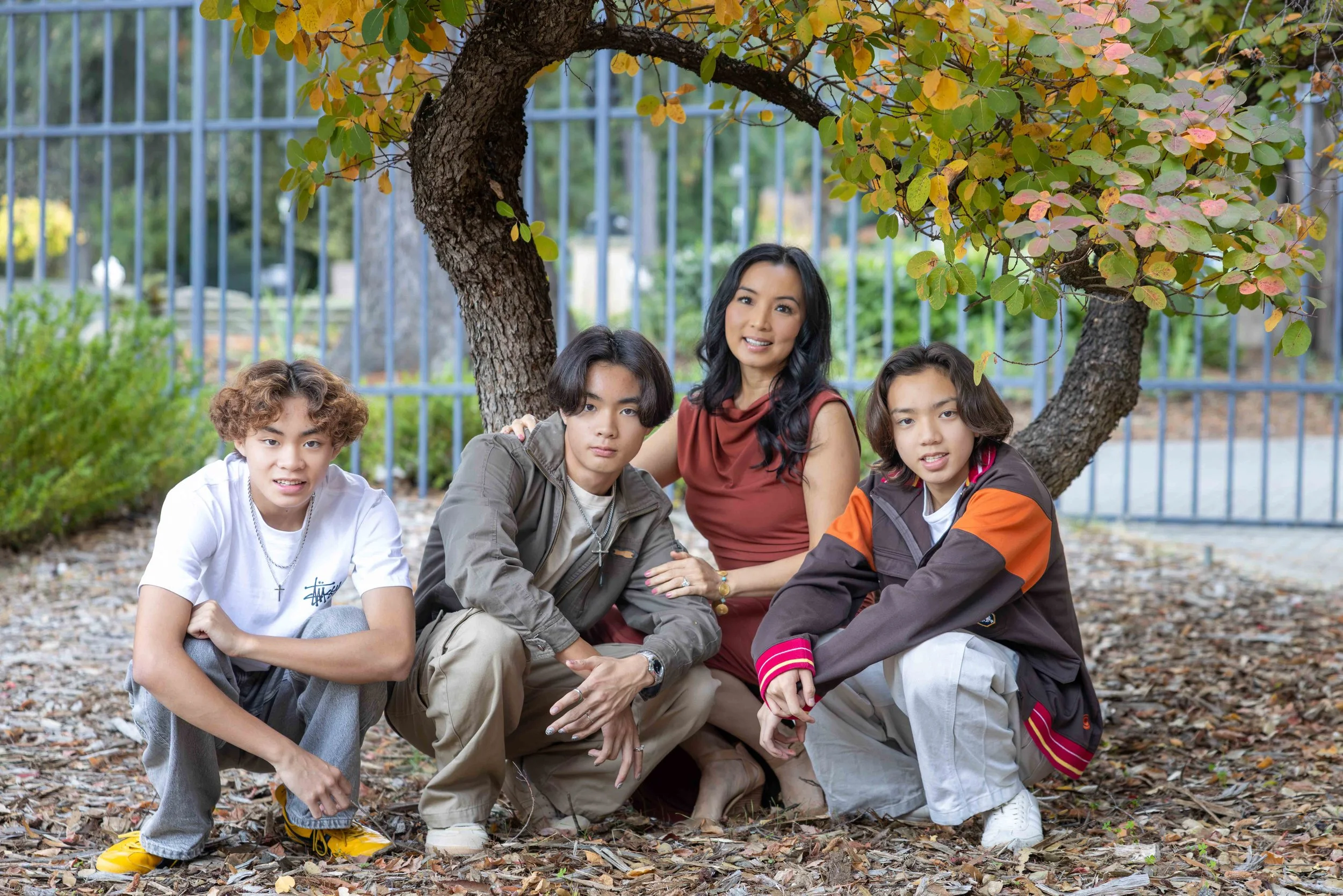 Mother with three teenage sons under a tree at a Bay Area family photography session