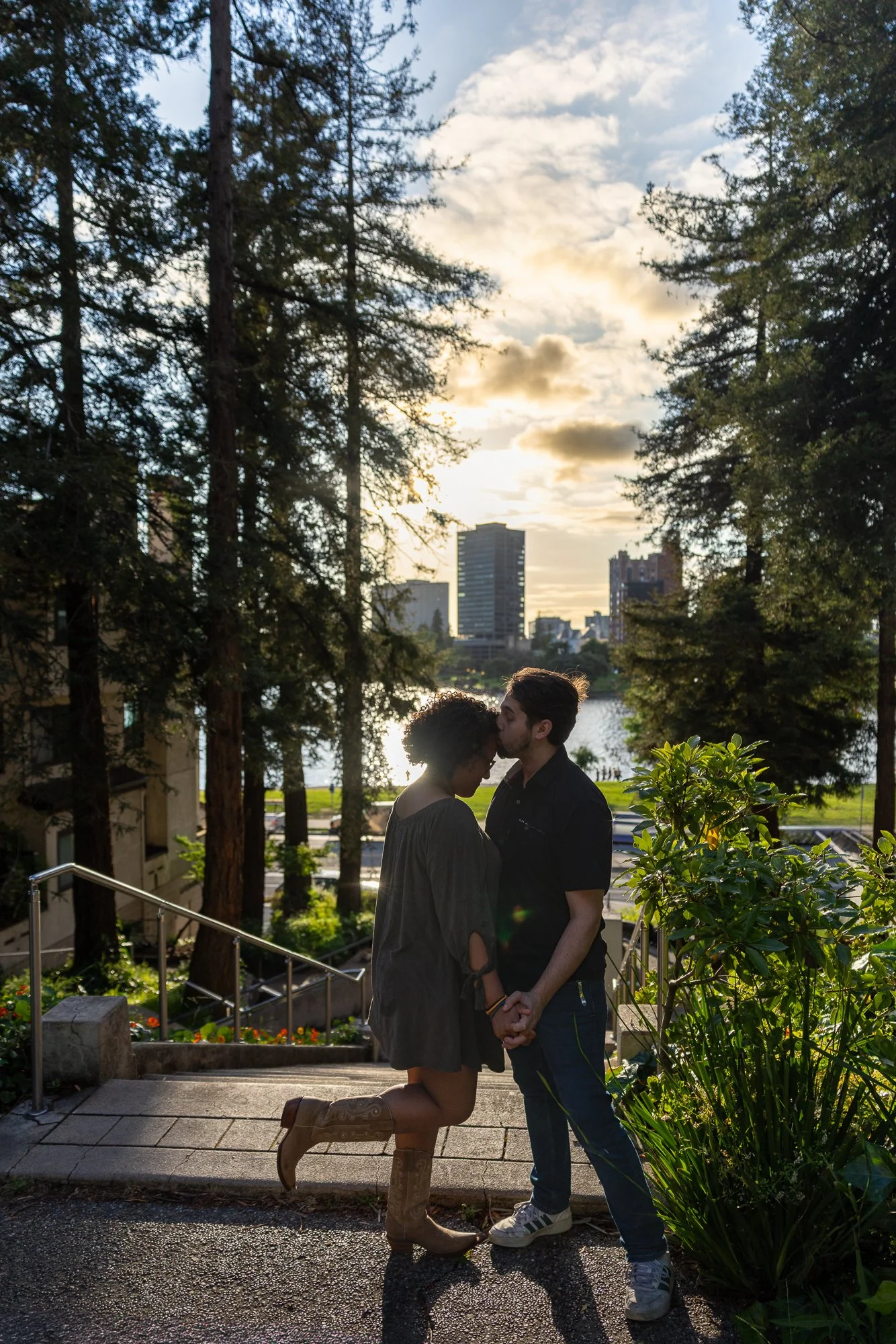 Bay Area couples session golden hour kiss on staircase with redwoods and skyline