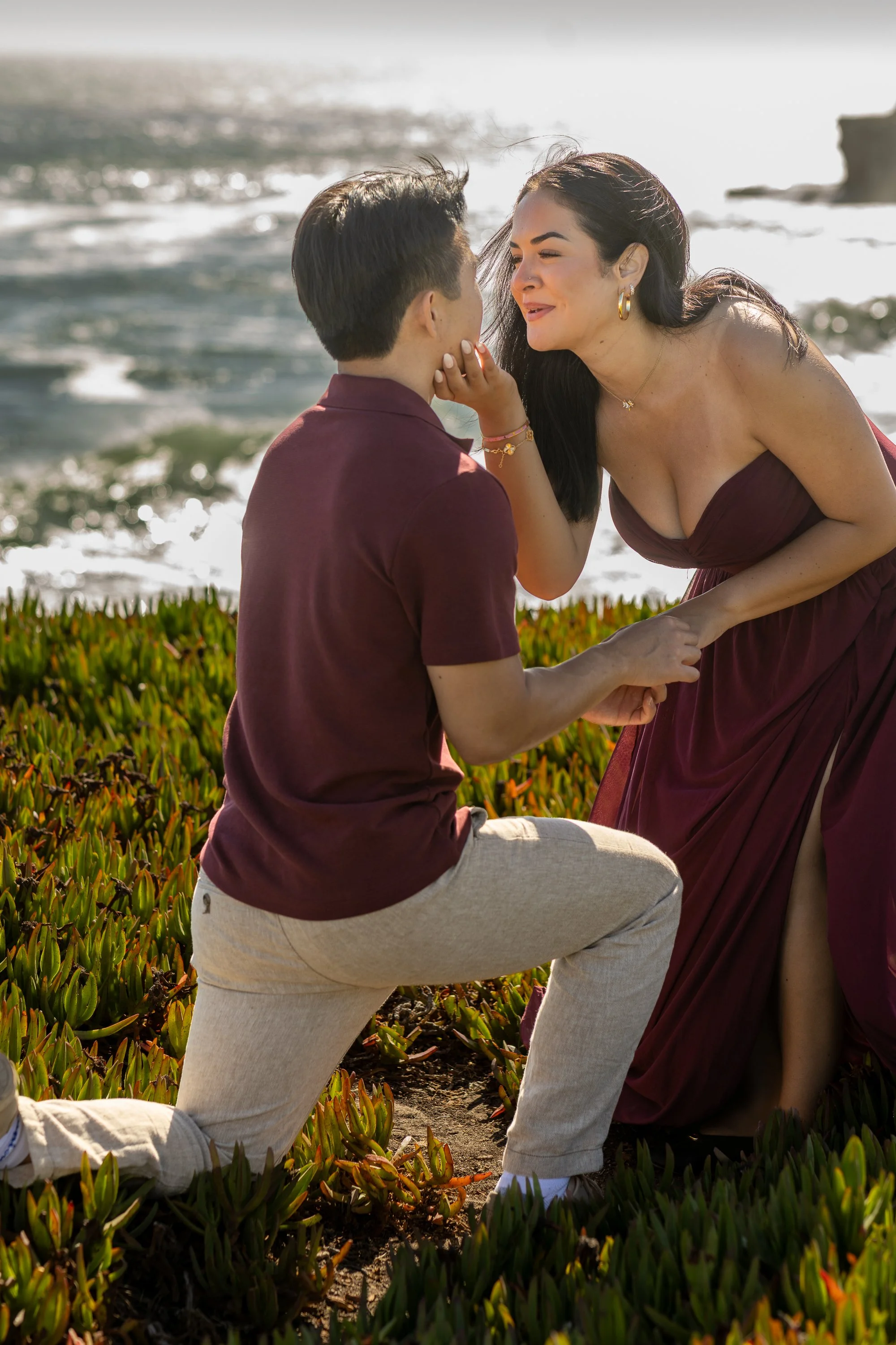 Man on one knee proposing on the bluff at West Cliff Drive, Santa Cruz