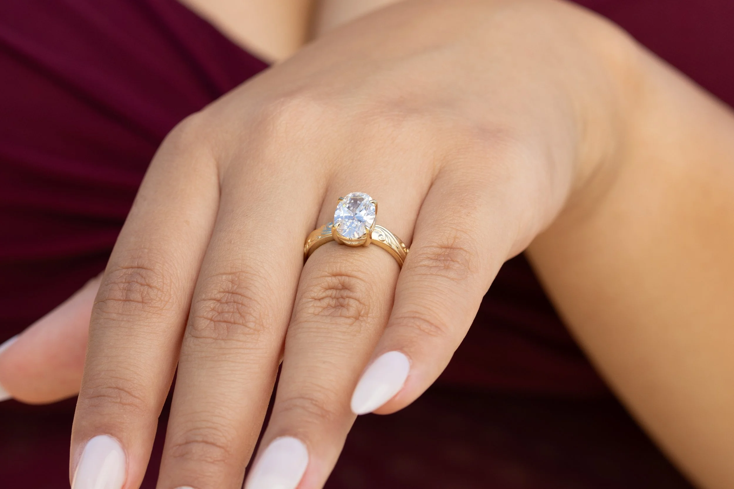 Macro close-up of an oval engagement ring on her hand after a Santa Cruz proposal