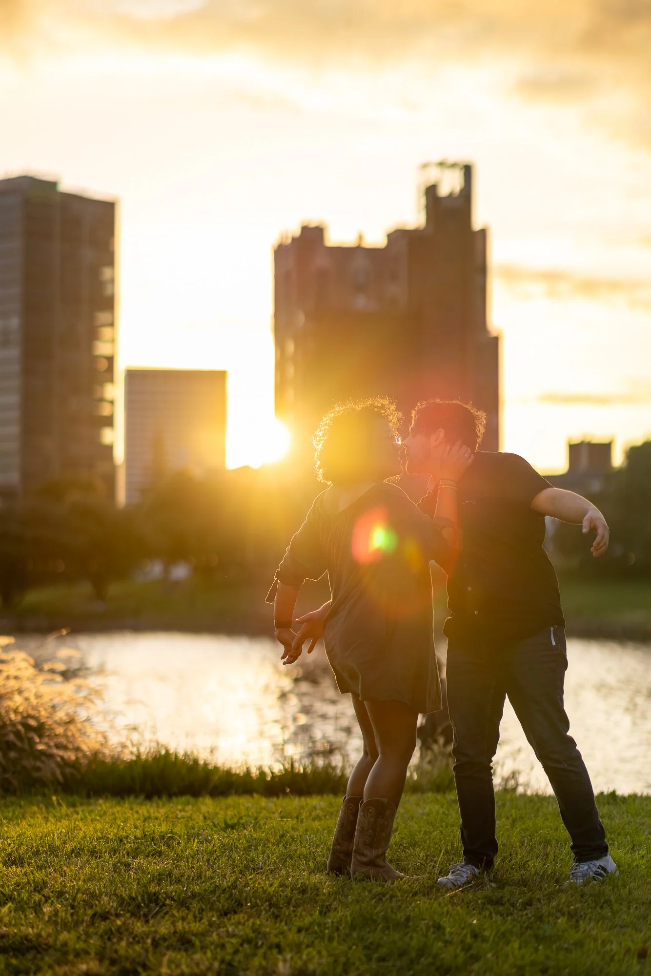 Bay Area couples photographer silhouette kiss against city skyline at sunset
