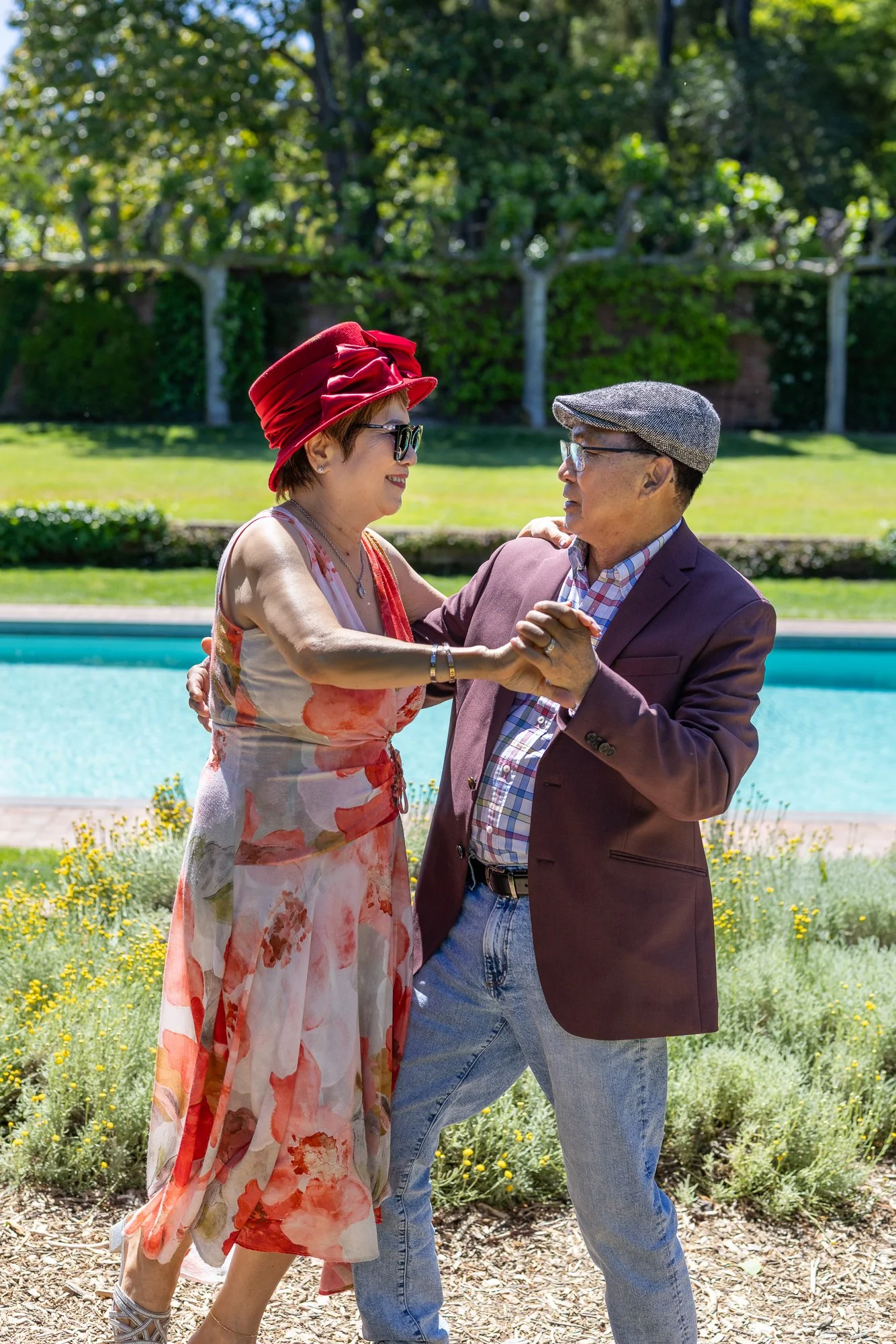 Older couple dancing by Filoli reflecting pool, classical ballroom hold, Bay Area spring portrait