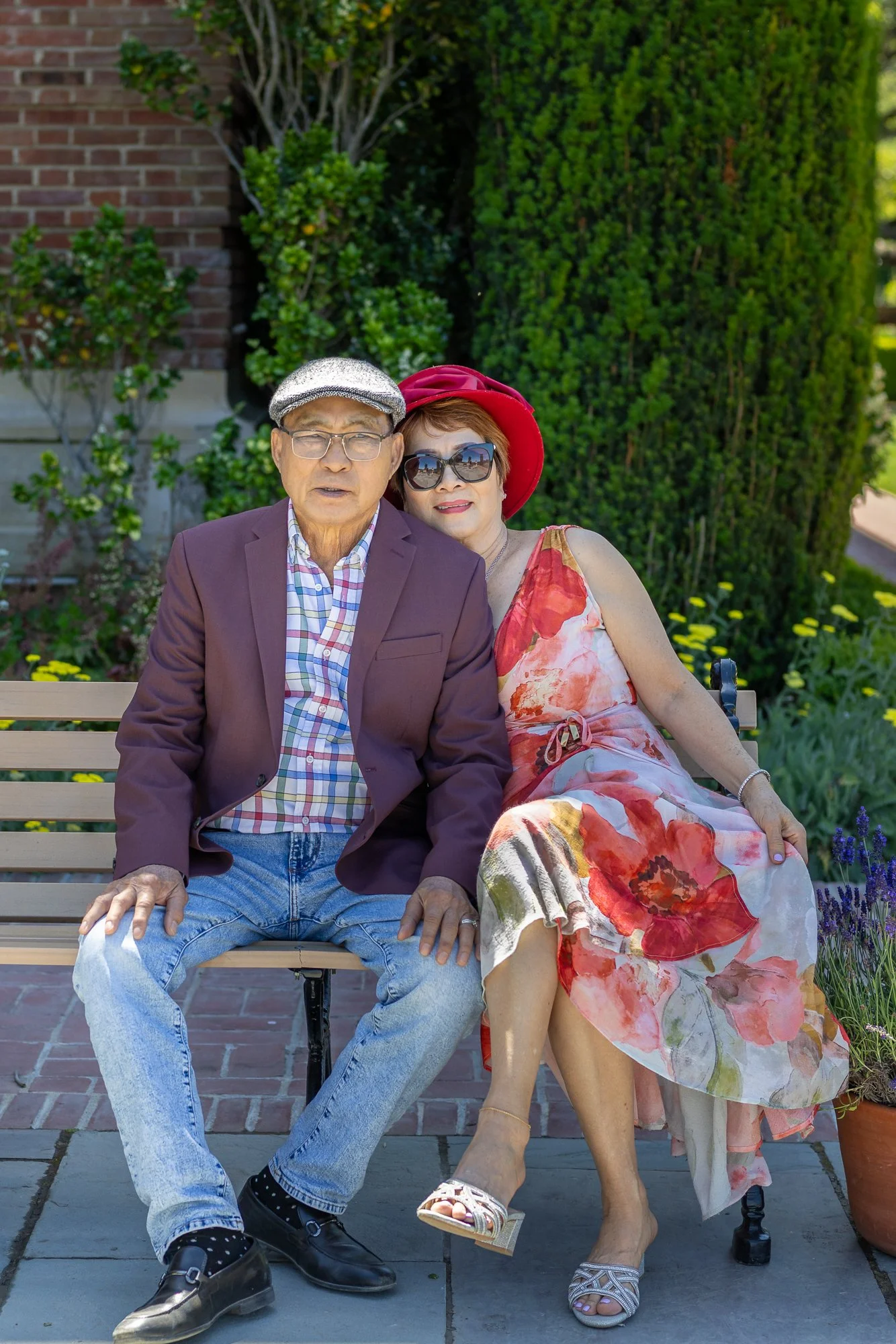Older couple on bench against brick wall at Filoli, quiet intimate spring portrait Bay Area