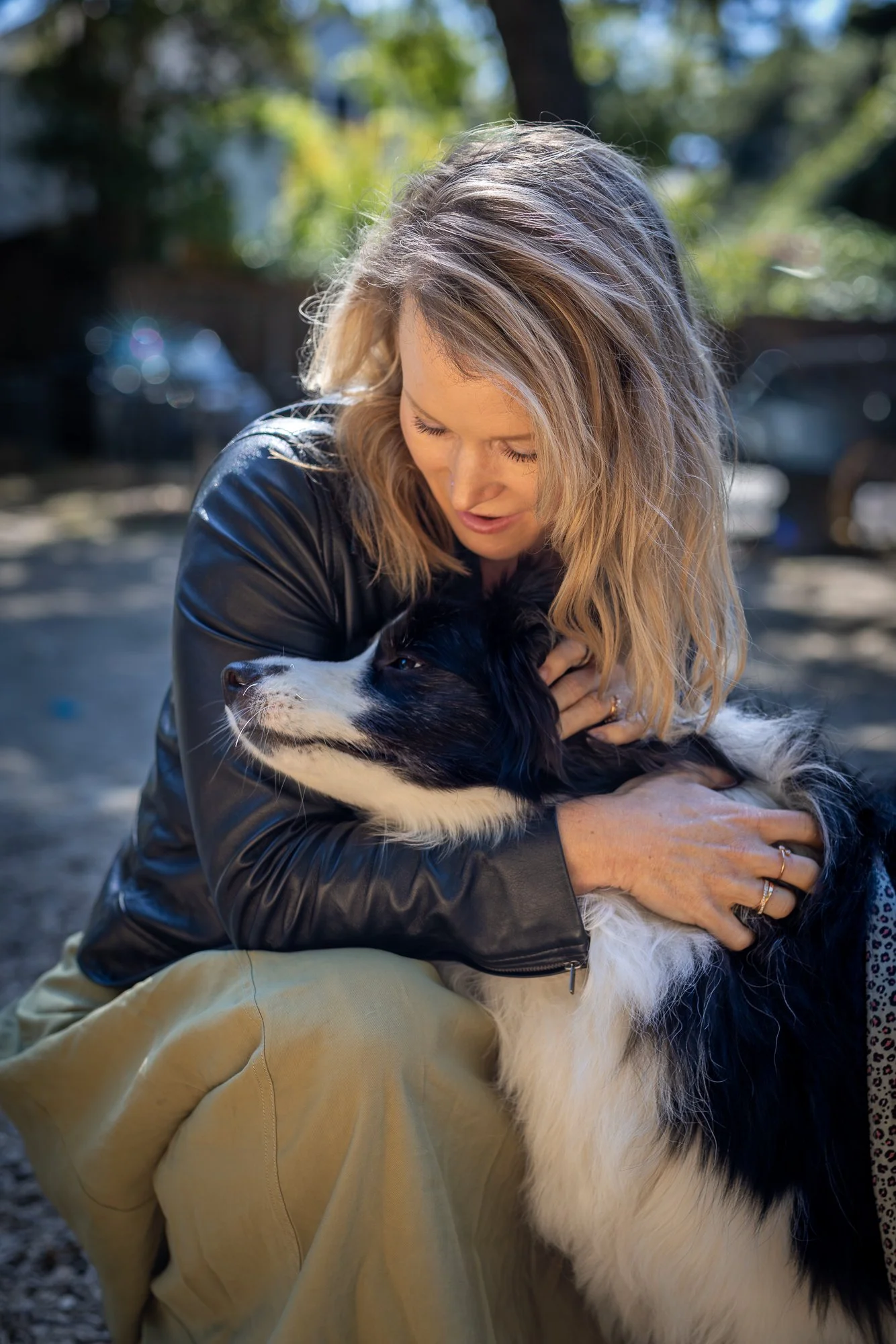 Mother and dog quiet moment in redwood grove Los Altos family photography