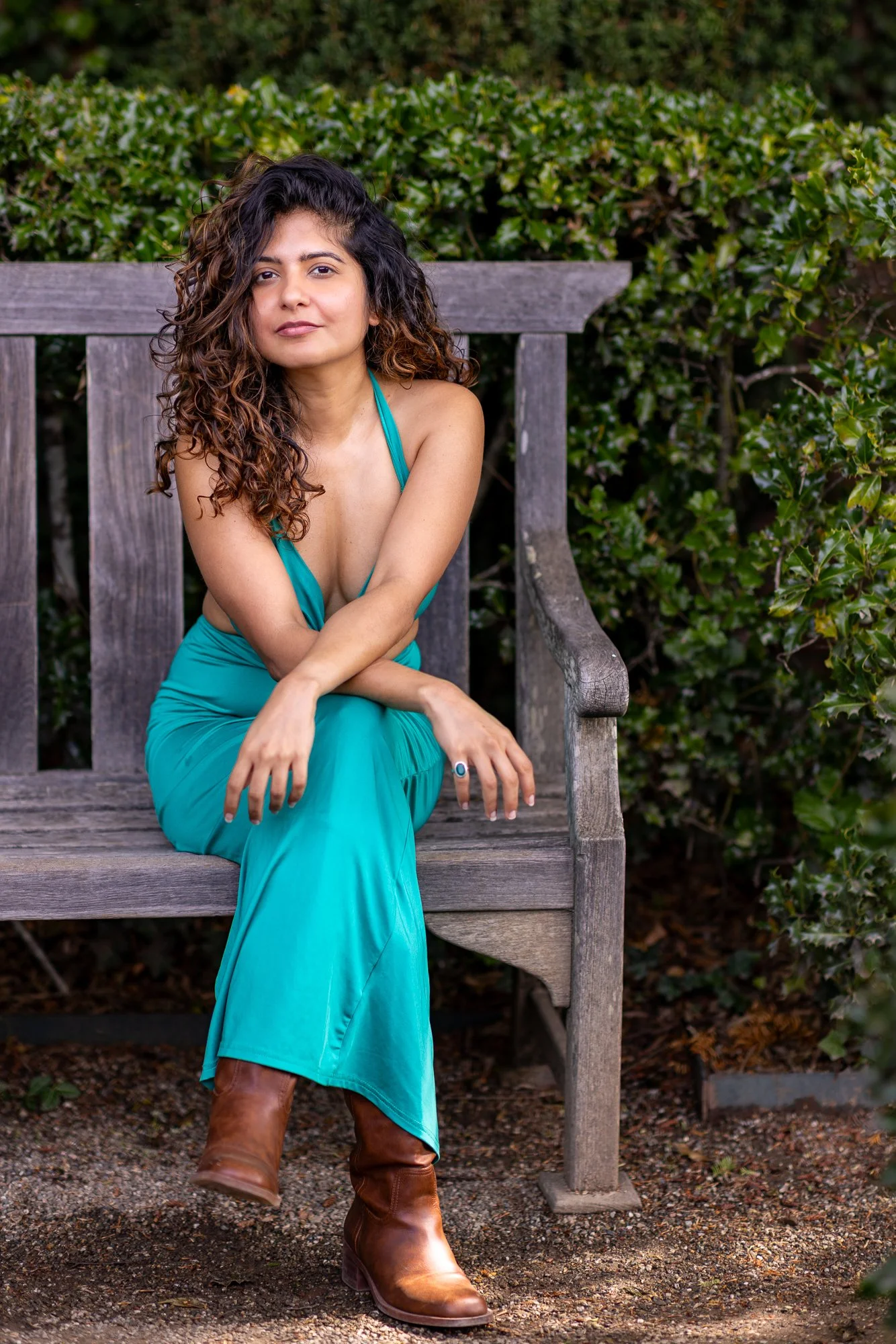 Woman in teal dress seated on garden bench at Filoli, natural light portrait, Peninsula Bay Area