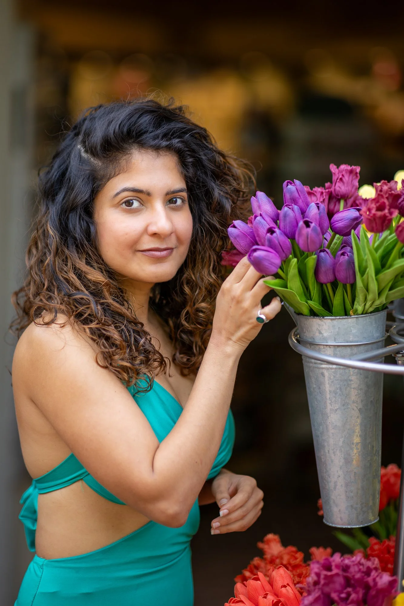 Woman near colorful tulip flower stand, natural light candid portrait, Bay Area personal lifestyle session