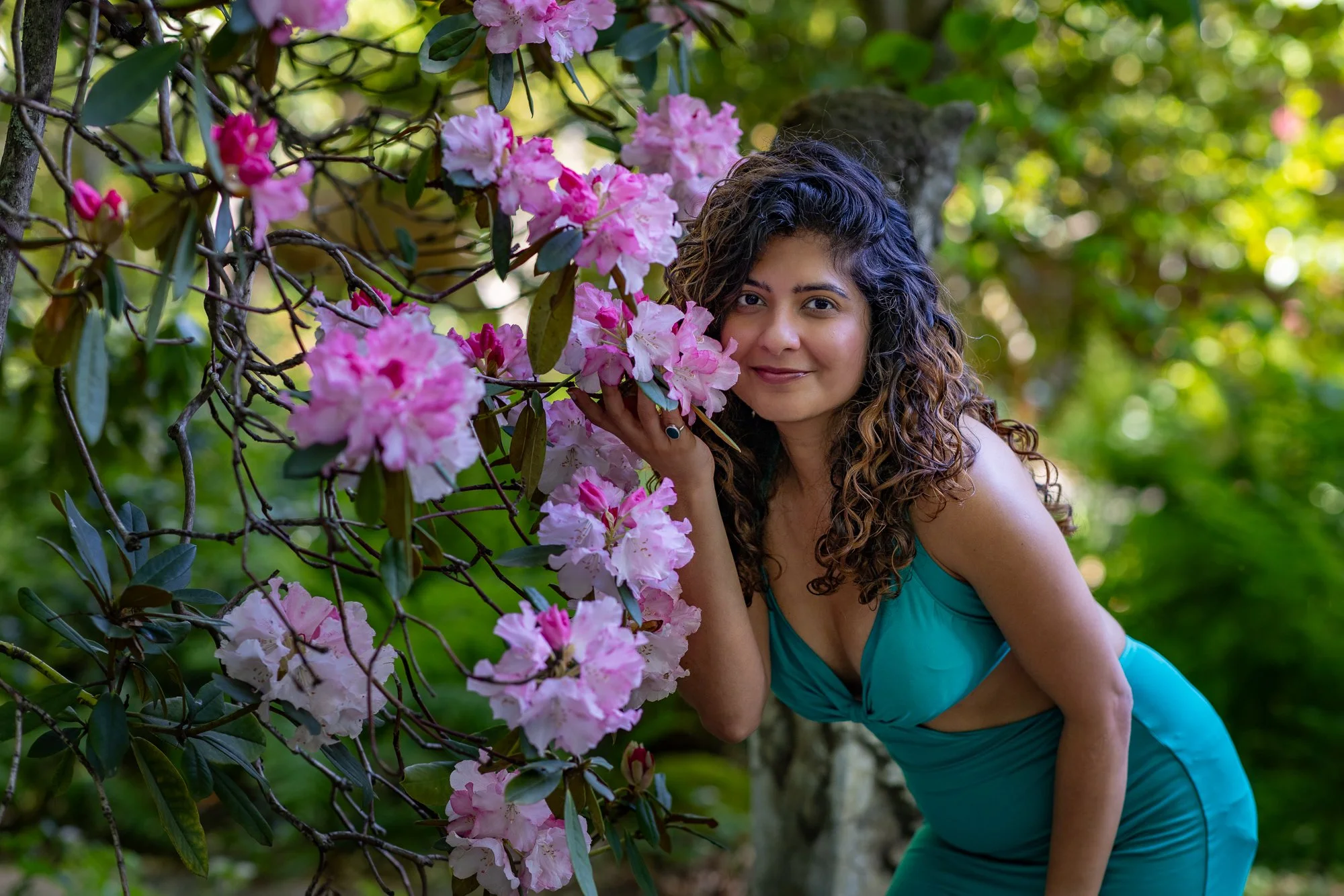 Woman in teal dress among pink rhododendron flowers at Filoli garden, natural light portrait, Woodside California
