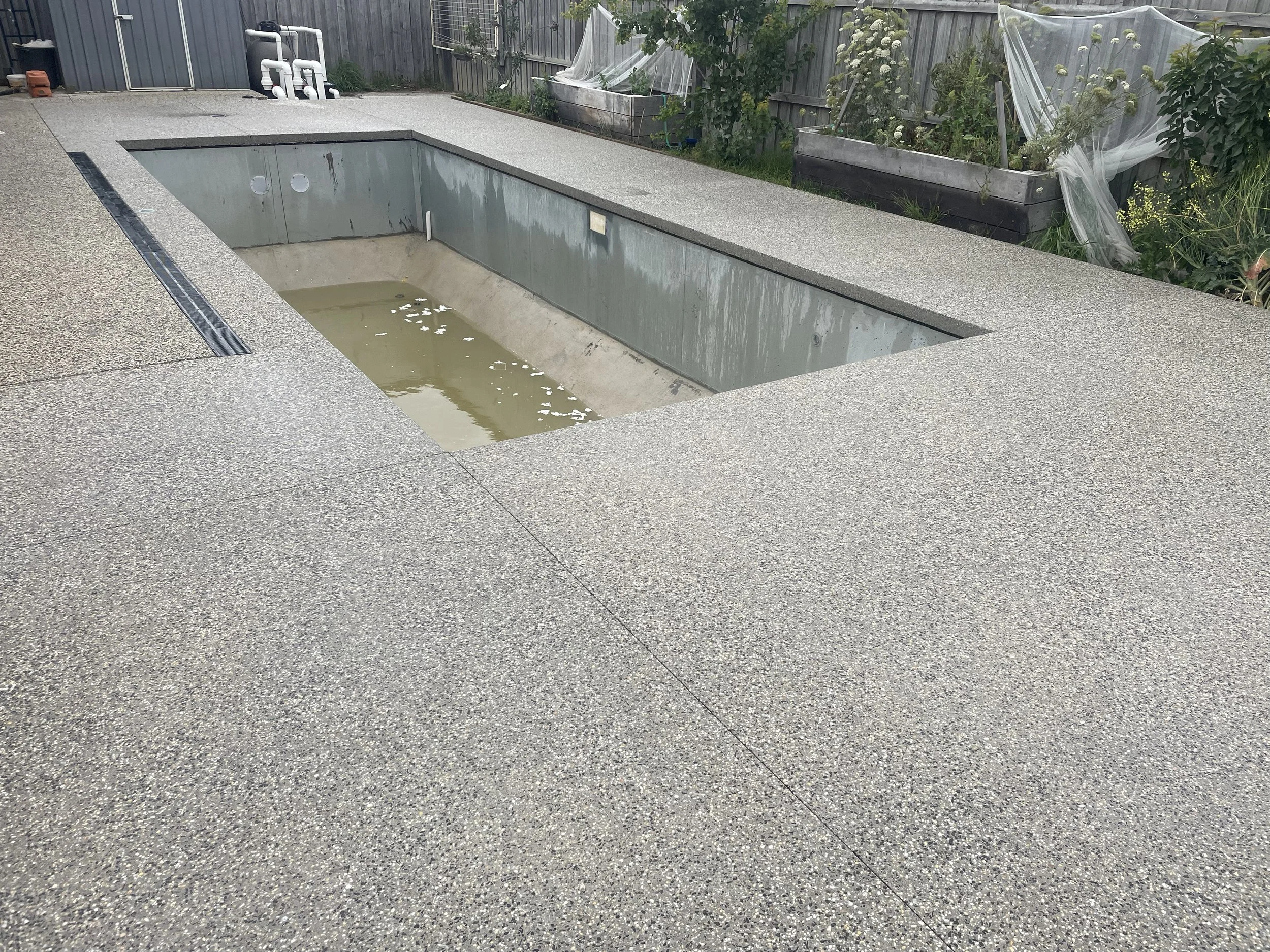 Exposed aggregate concrete pool surrounds