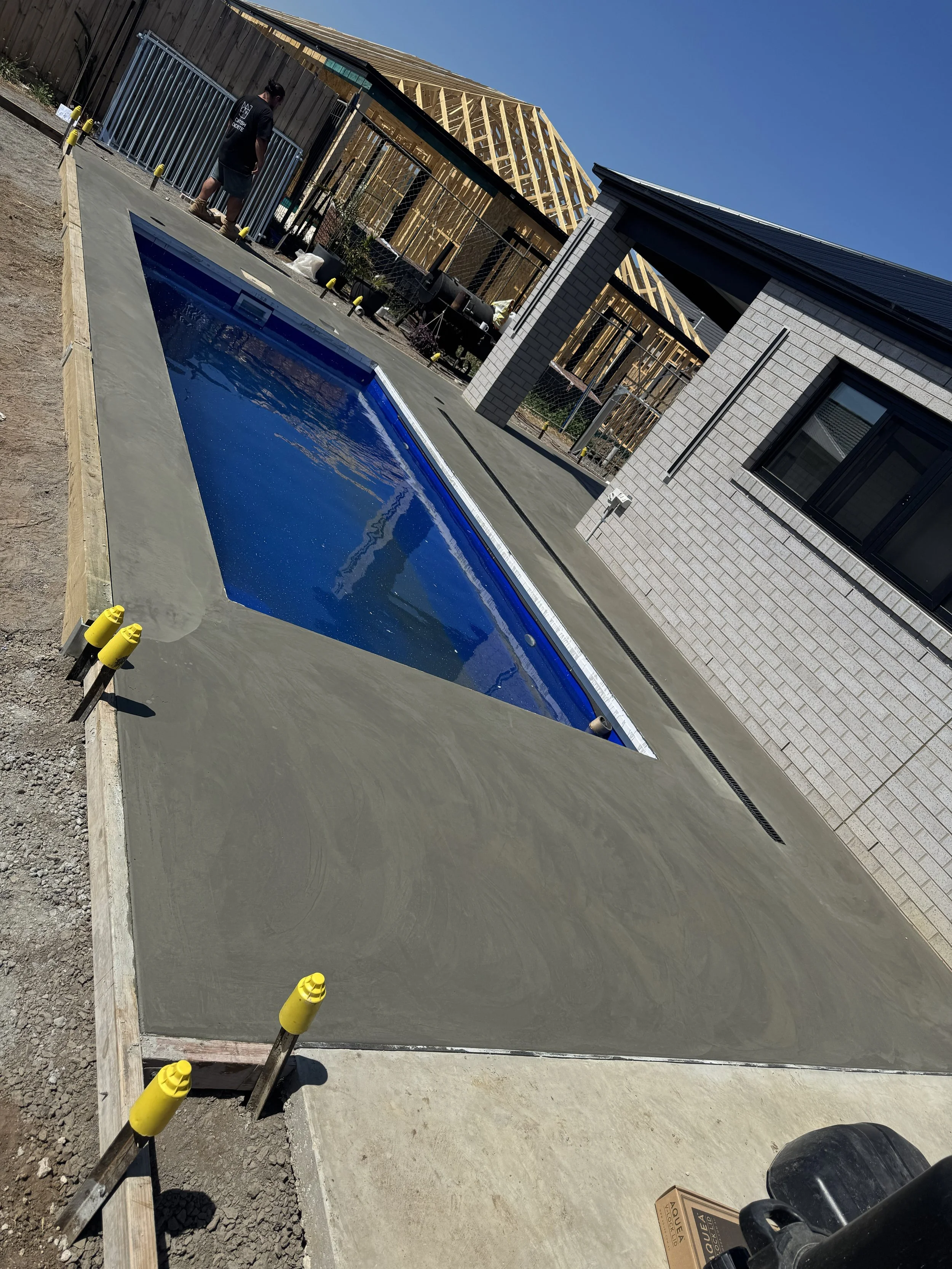 Hand burnished concrete pool surrounds