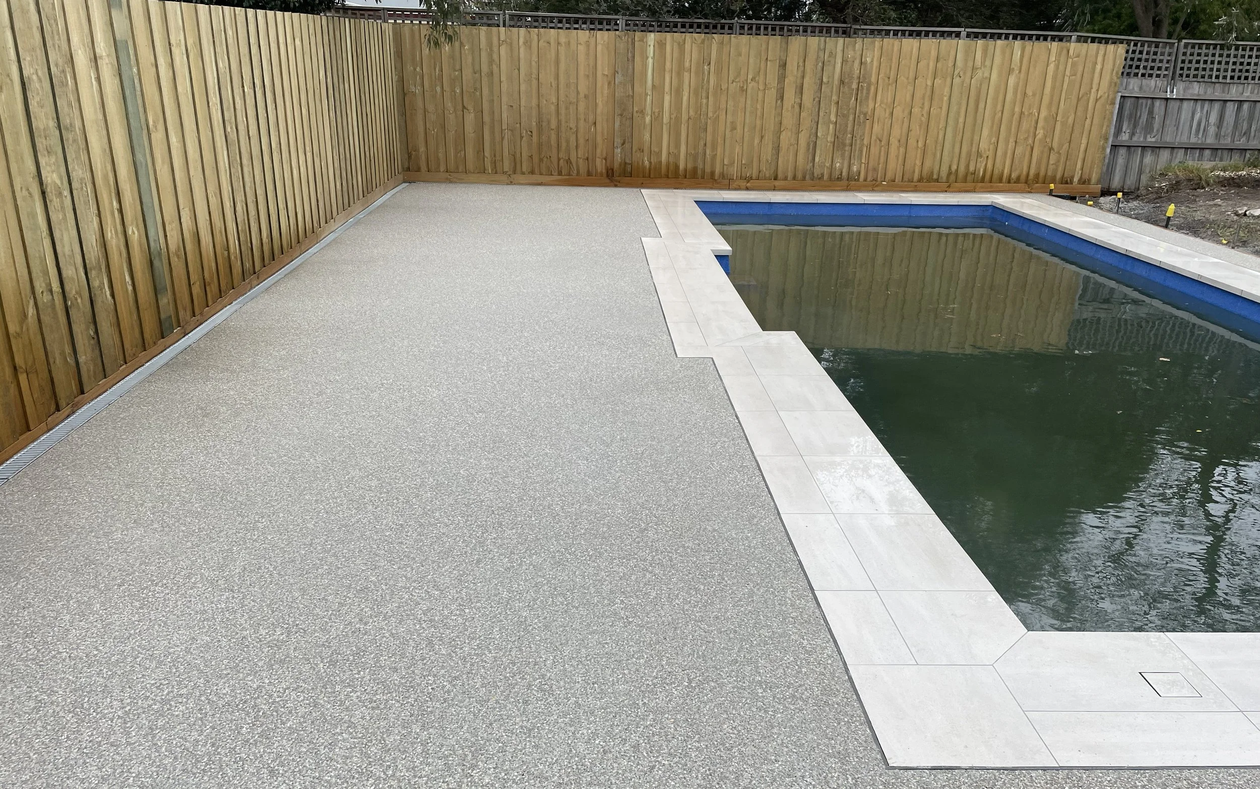 Exposed aggregate concrete pool surrounds
