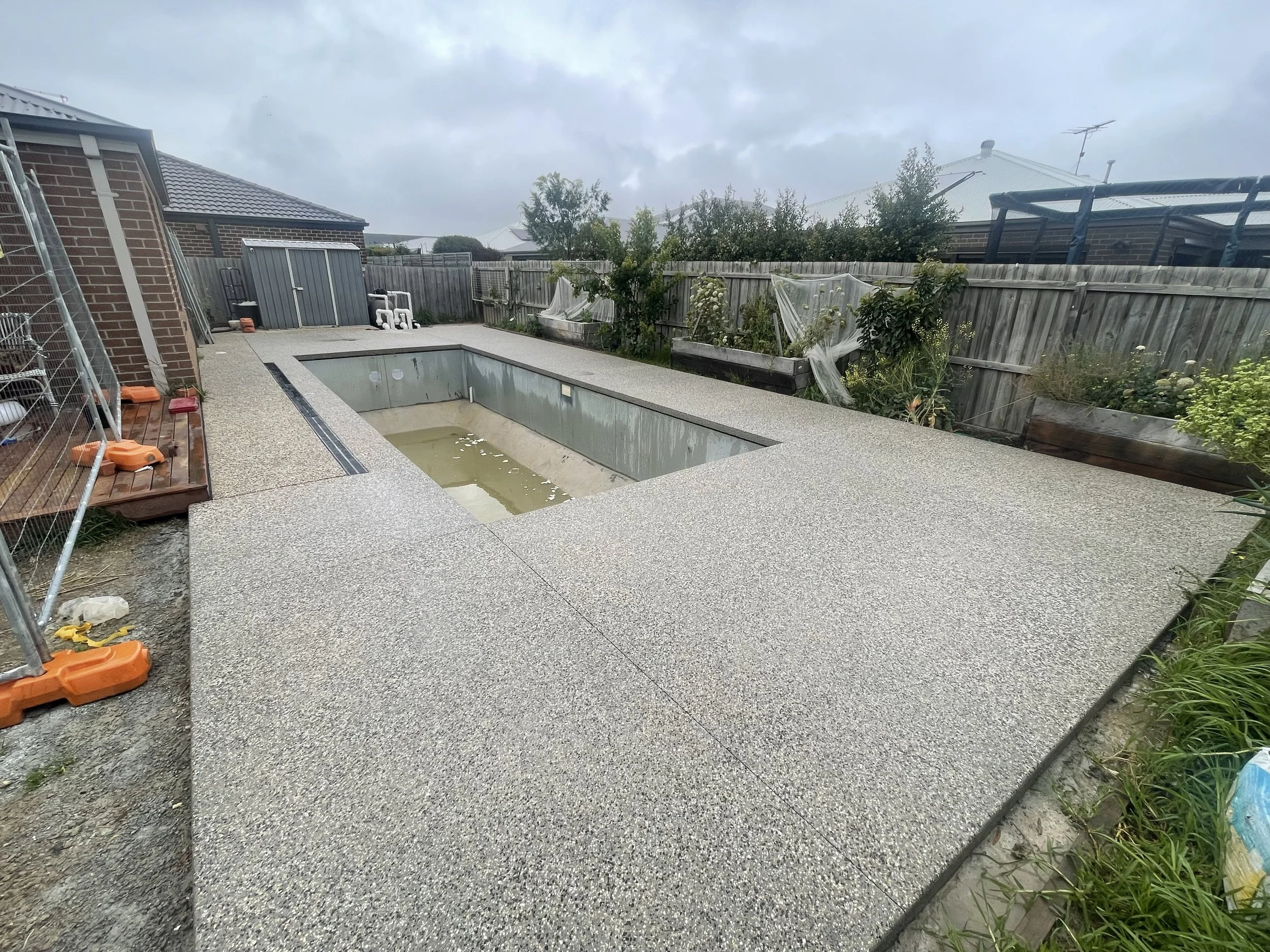 Exposed aggregate concrete pool surrounds