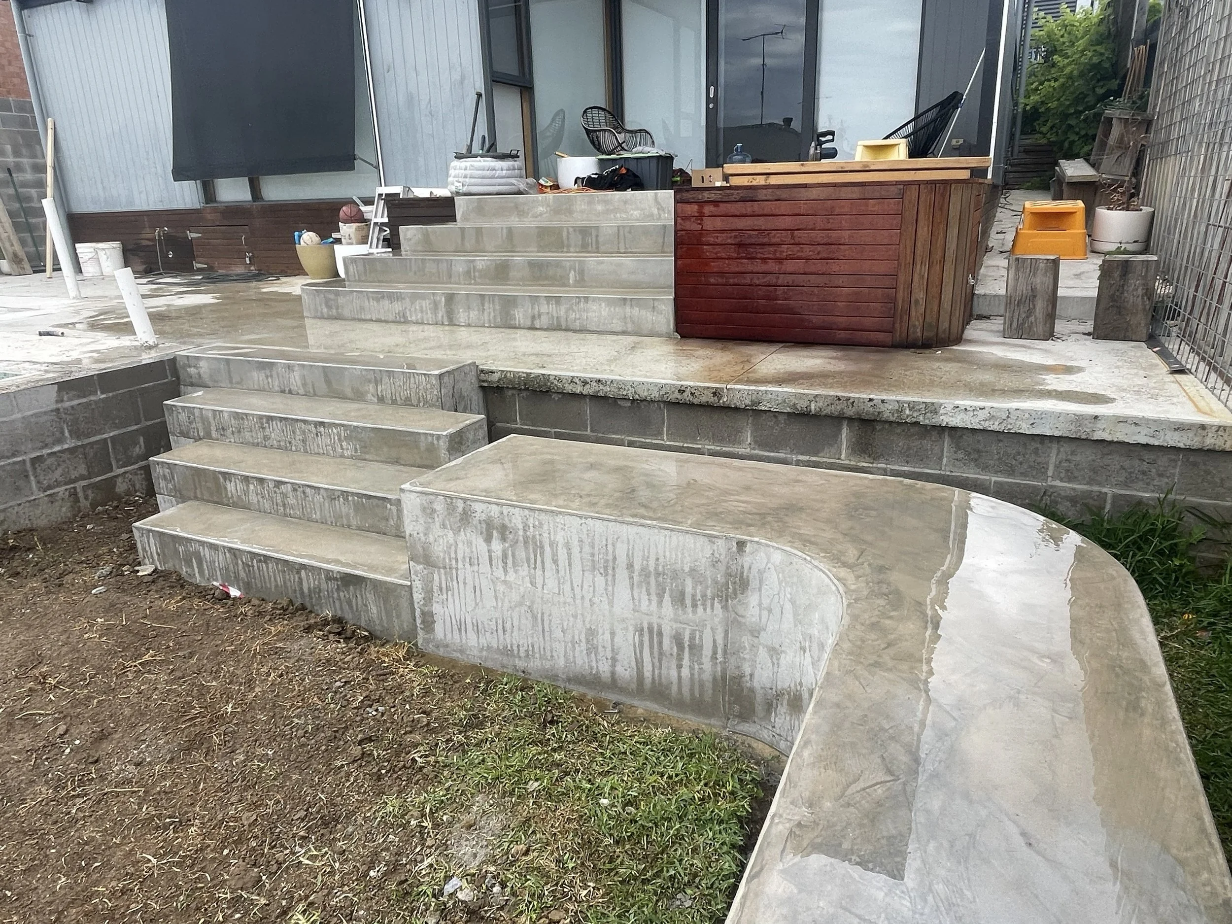 Hand burnished concrete bench seat and block steps