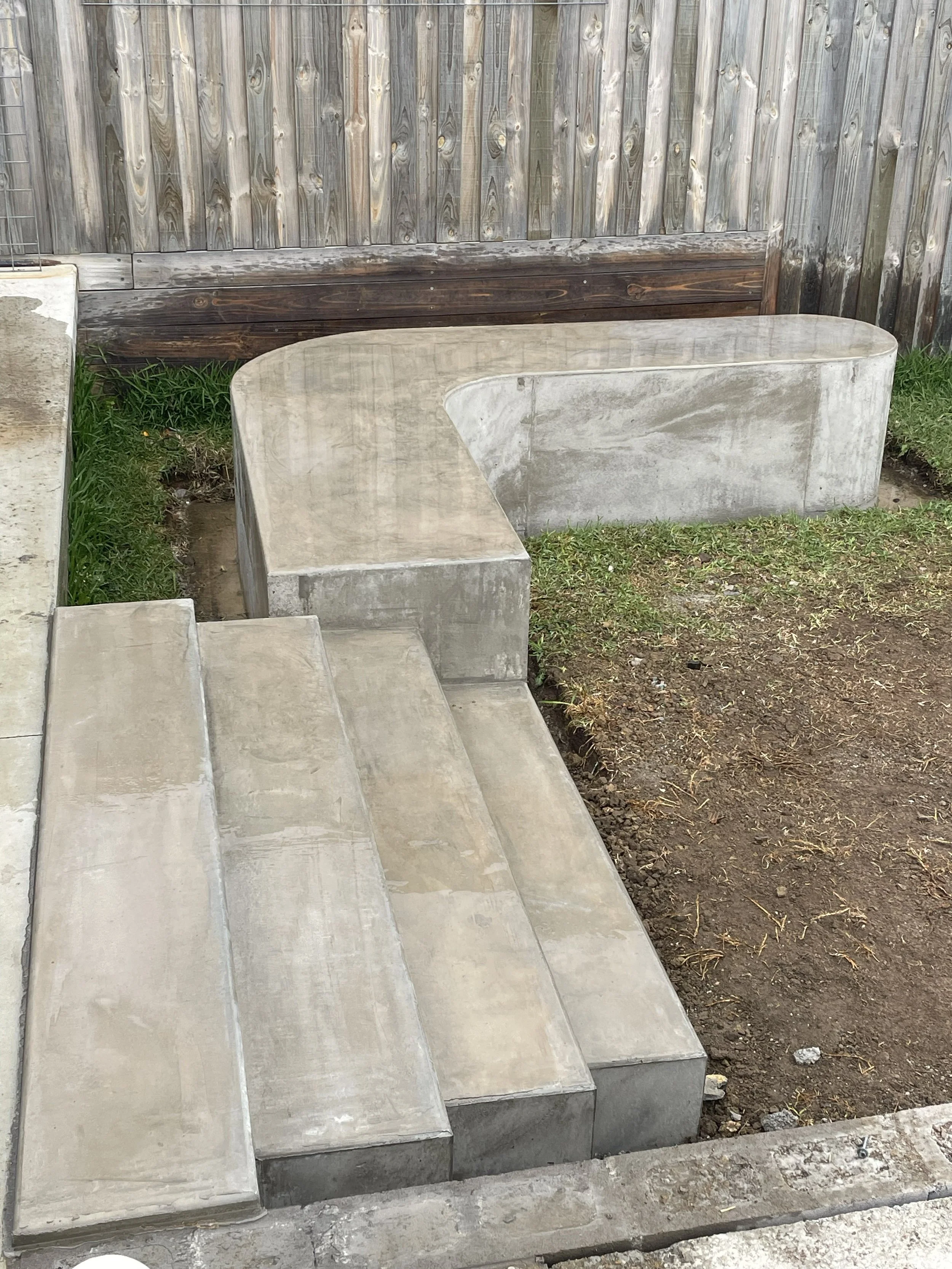 Hand burnished concrete bench seat and block steps