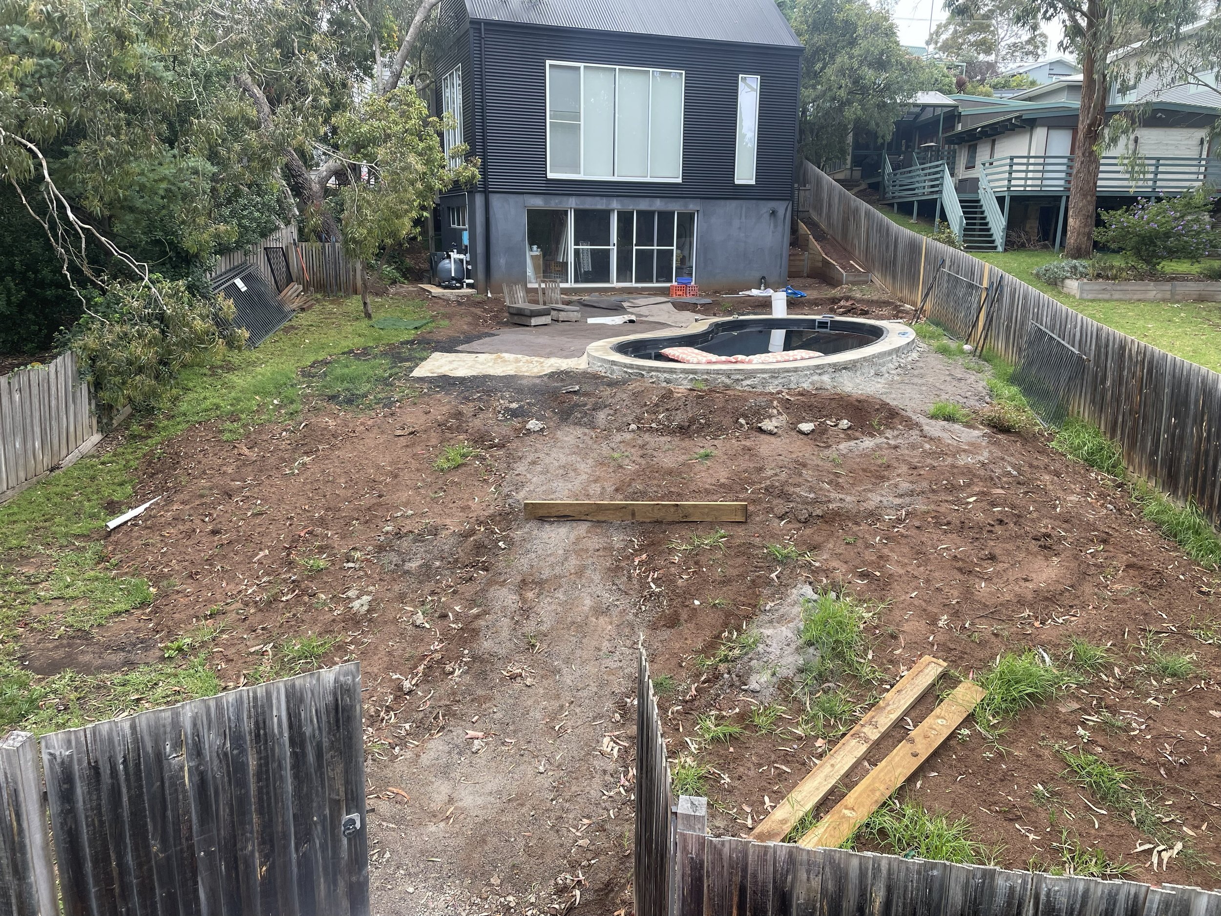 The before shot of, Rock salt finished concrete pool surrounds and shed slab with retaining walls and fresh turf all done by the Everstone team