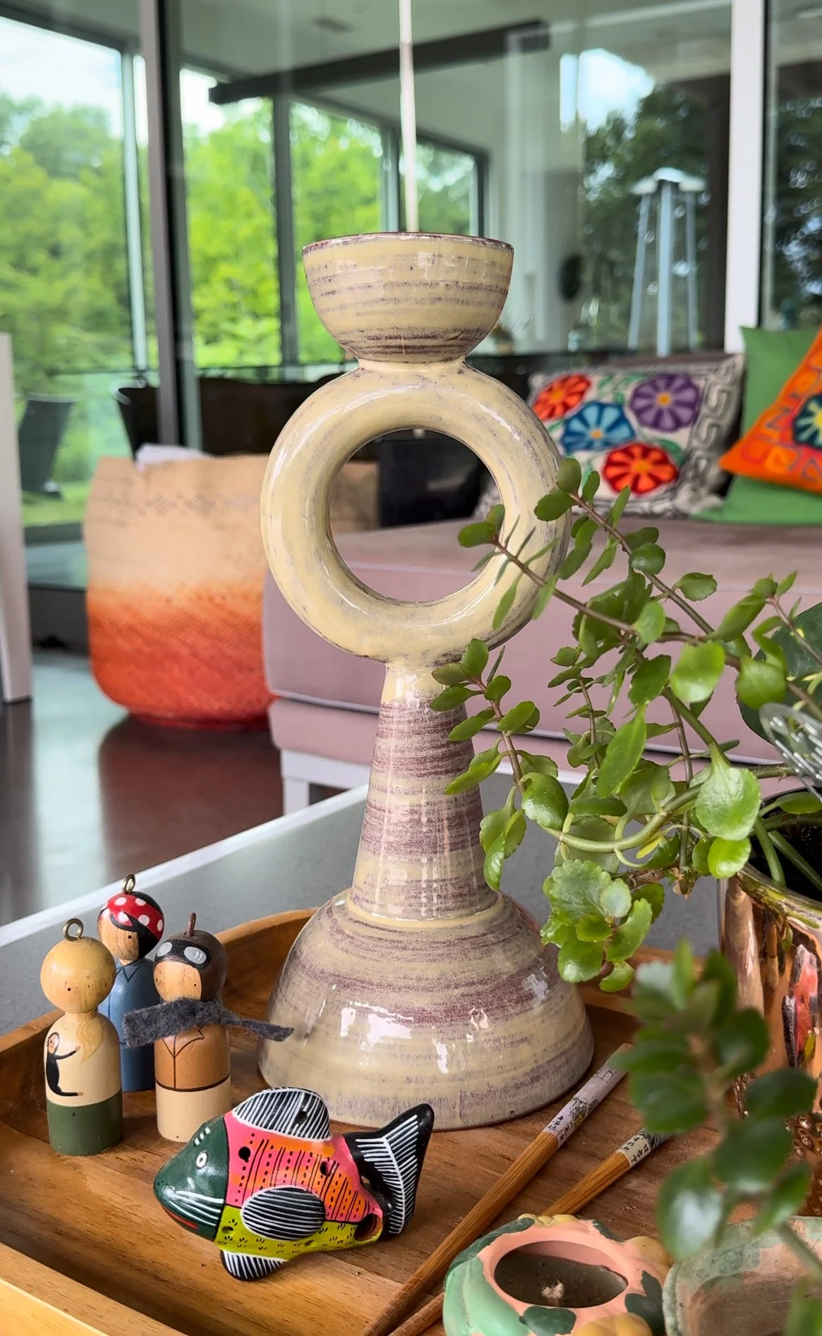 A geometric pastel green sculpture featuring a loop donut form.