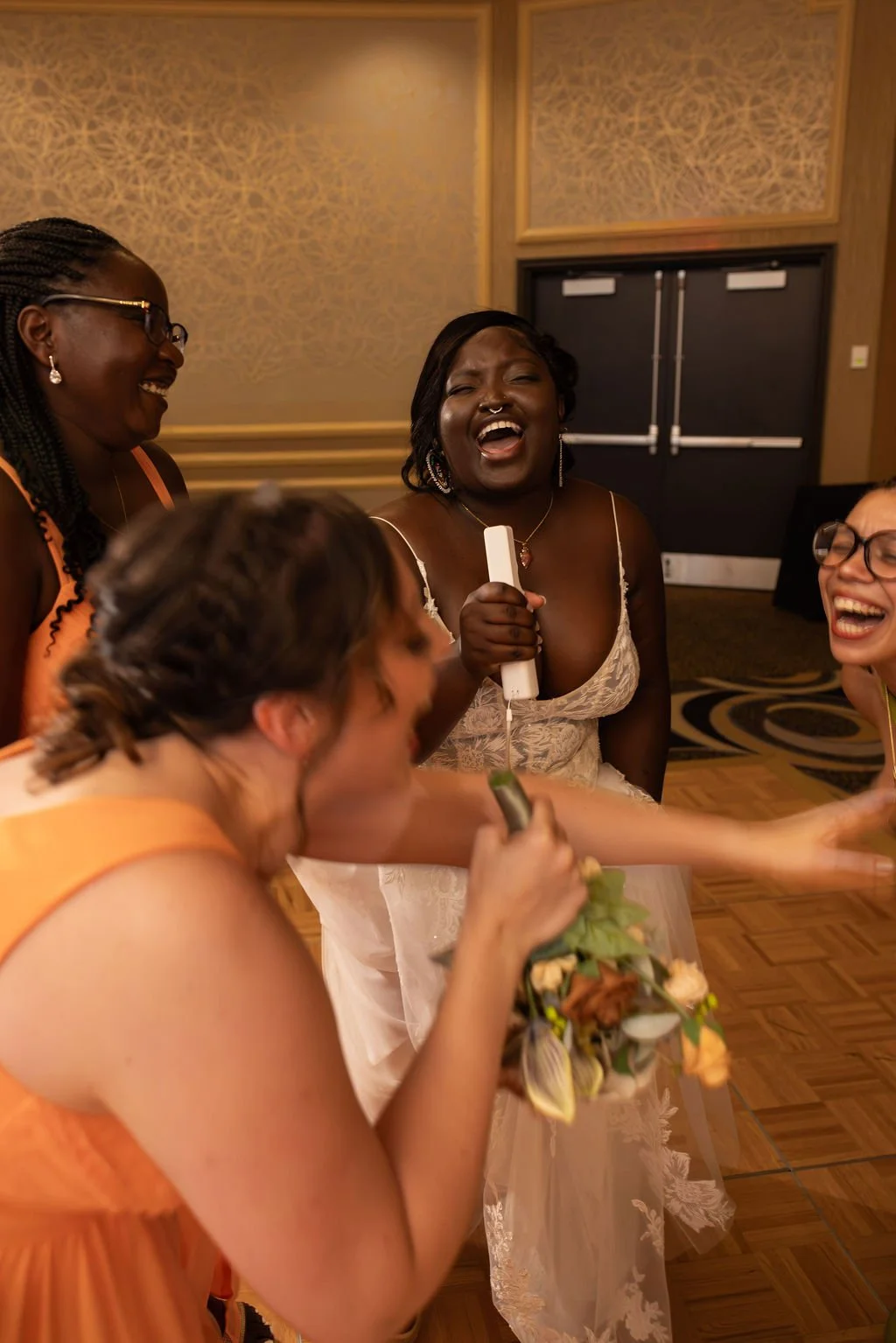 Three bridemaids and a bride singing with pretend microphones