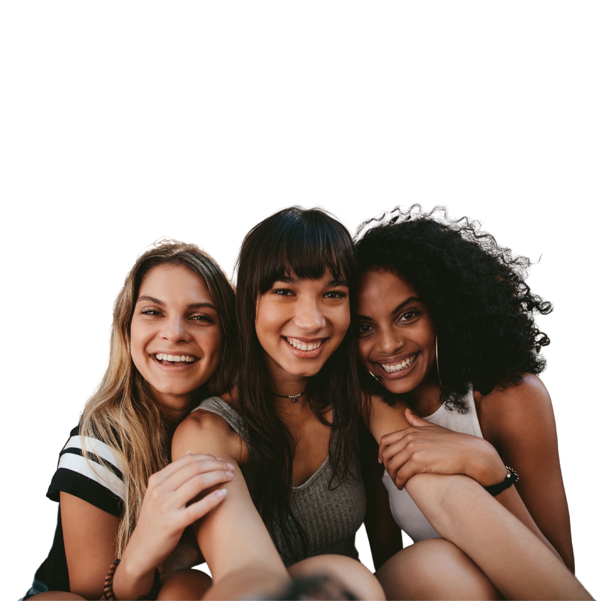 Three smiling women of diverse ethnicities close together, taking a selfie.