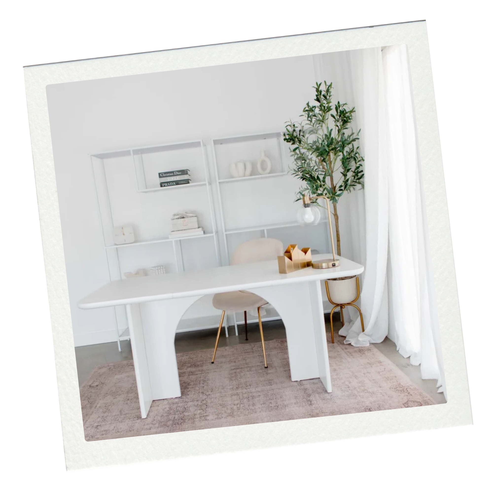 Minimalist home office with white desk, beige chair, tall indoor plant, white bookshelves, decorative objects, and white curtains.