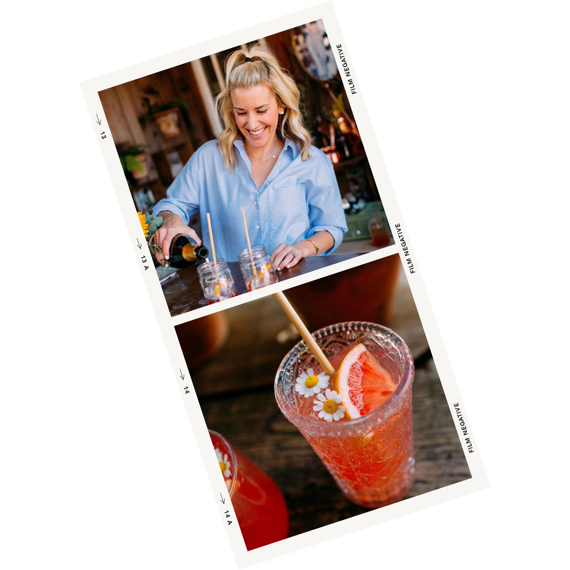 A woman with blonde hair in a ponytail and wearing a light blue shirt is pouring a beverage into jars on a bar or counter. The beverage appears to be pink with slices of grapefruit and small white daisy flowers with yellow centers floating on top, suggesting a summery drink.