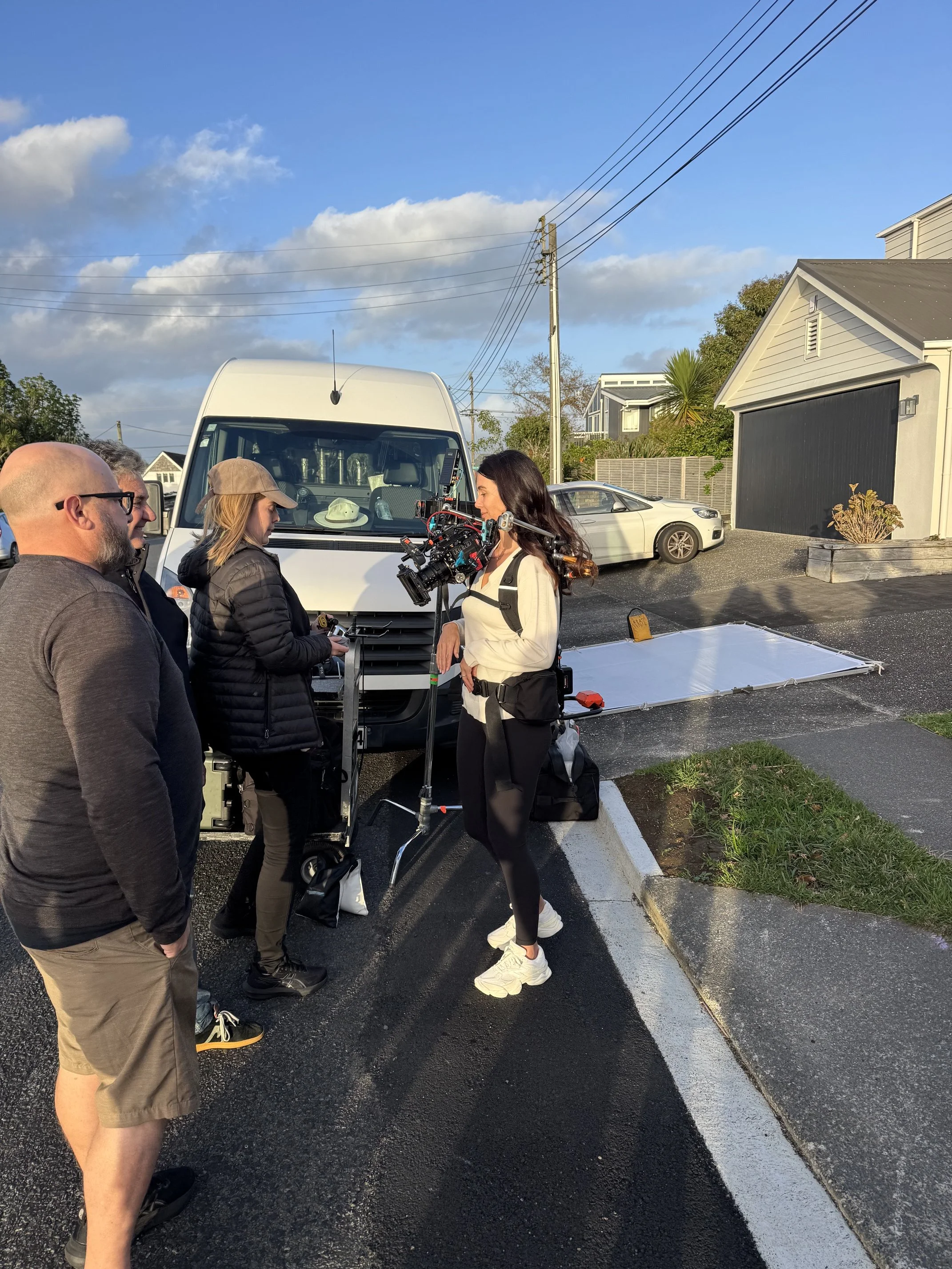 Four people stand preparing for a shoot