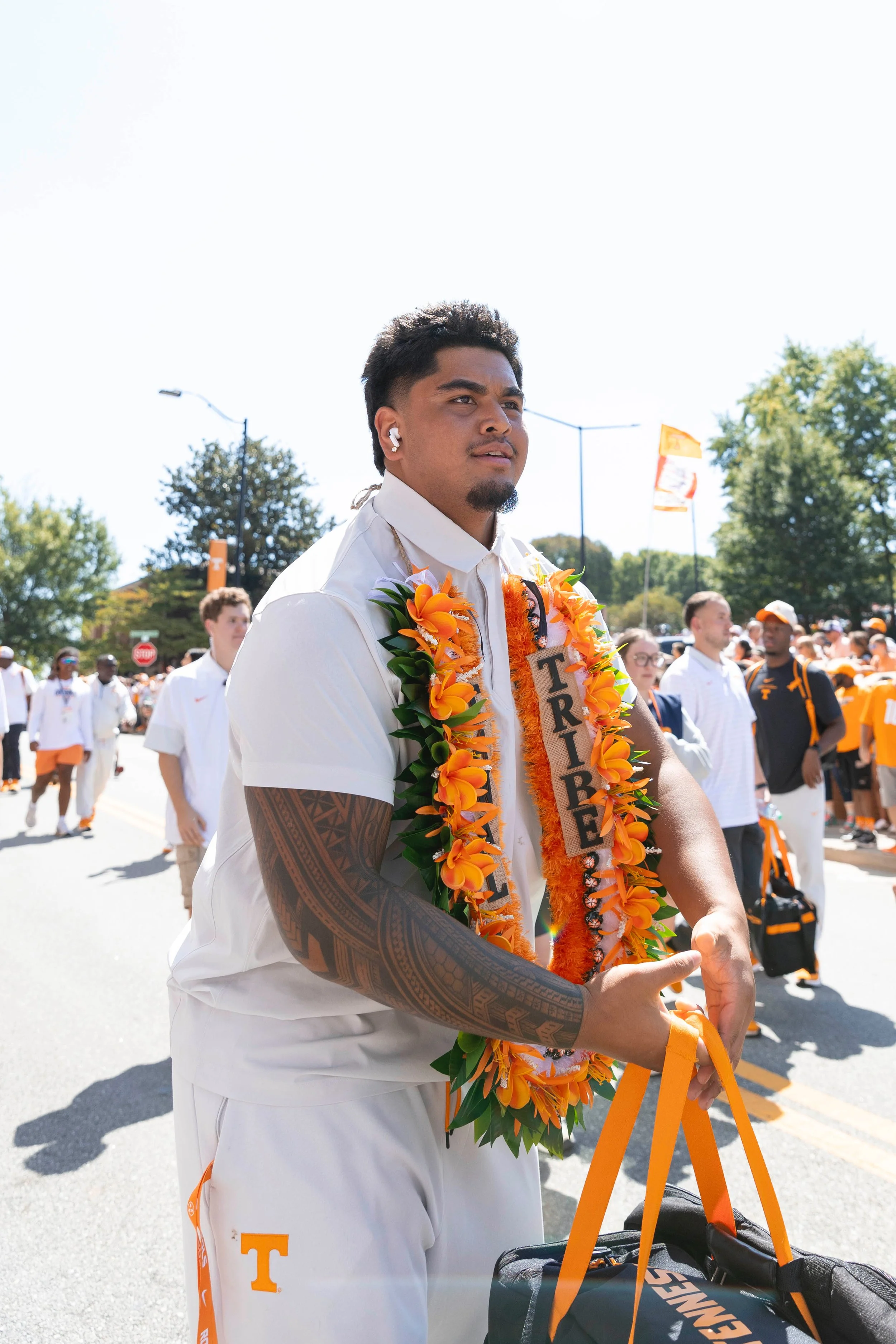 Antoni Ogumoro walks through the crowd during the "Vol Walk" at Neyland Stadium wearing his decorative lei representing his culture and island of Saipan